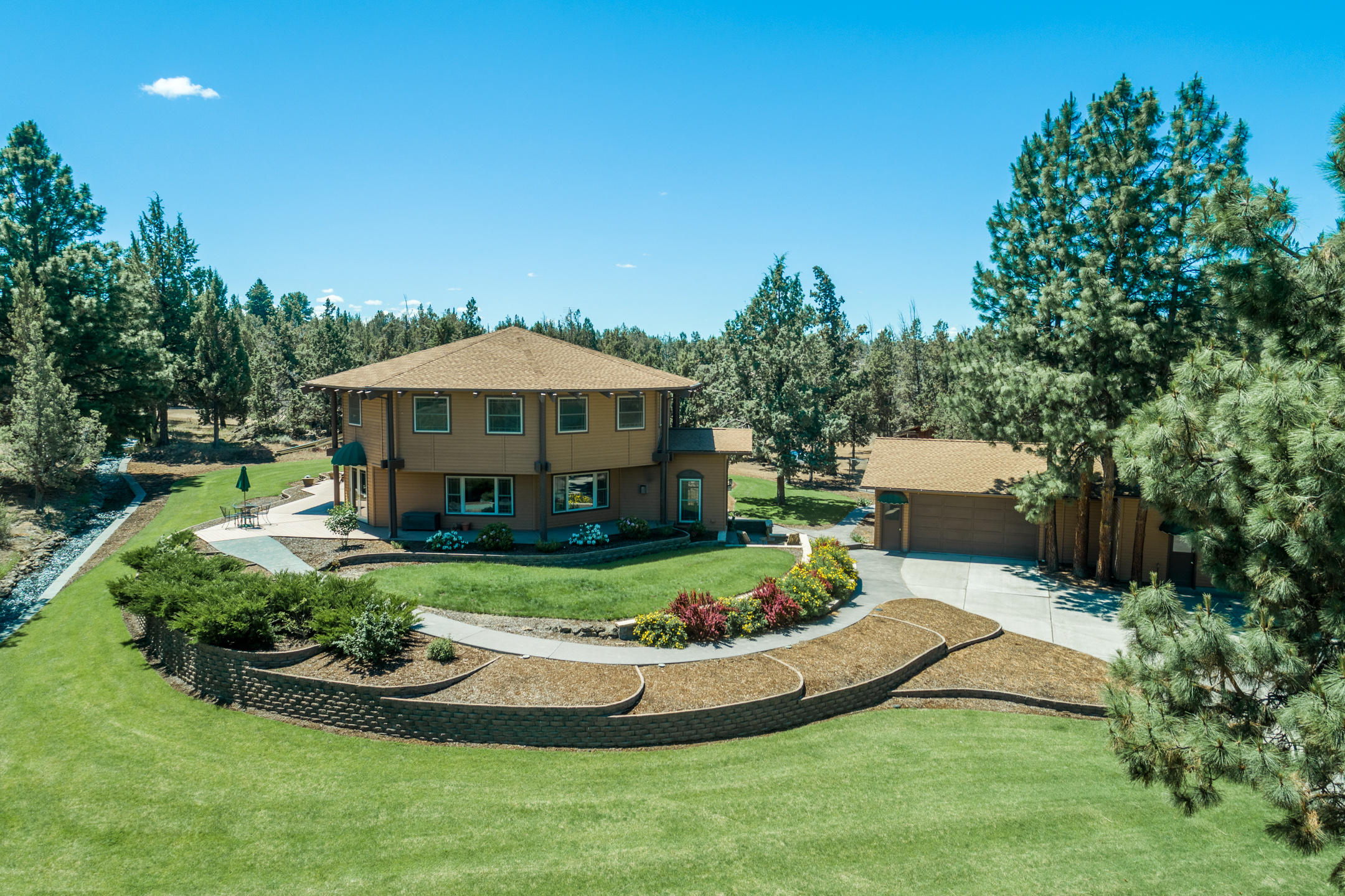 Truly unique and one of a kind, this incredible home is an engineering marvel. Meticulously built and lovingly maintained, the home is filled with architectural excellence!  A few of the many features this extraordinary property offers is a massive chefs kitchen, which includes 3 sinks, two dishwashers, a trash compactor, two ovens, a warming drawer and huge pantry. The flowing floor plan has radiant floor heat throughout the entire first level, natural light pouring in through every window, and an astonishing amount of cabinets and storage in every single room. The enormous master suite includes a luxurious spa bathroom with heated floors, his and her shower area and oversized jetted tub. With a finished 1,100 sq ft basement showcasing multiple rooms, a full bathroom and private exterior entrance, the possibilities are endless! Add the huge shop, irrigated pastures, beautiful pond and bubbling canal, you have a private slice of heaven and a rare offering of incomparable value!