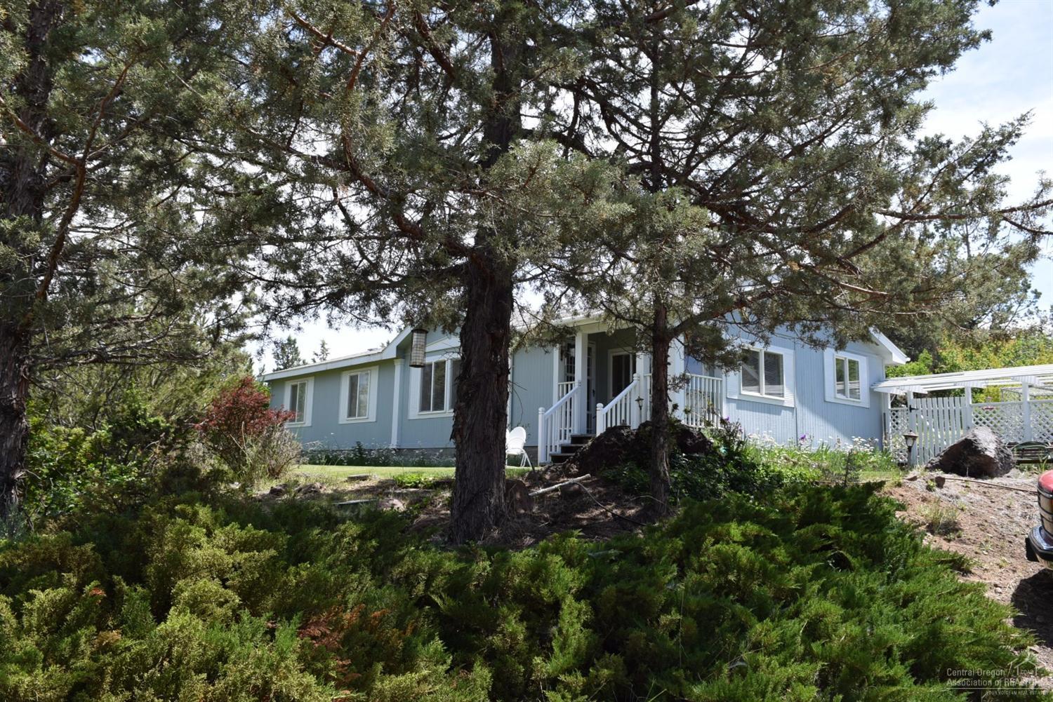 Master Gardeners private retreat, gorgeous perennial gardens, roses, grapes, fruit trees, thousands of dollars of exotic sedum's taking years to cultivate. Rocks hauled from Terrebonne complete this showpiece from the deck and so much more. Spacious mfd 1512 sq ft 3 bed, 2 bath, large kitchen. Detached 2 car garage with shop area, 10x12 storage, 10x12 greenhouse on 2.5 acres. The work is done for you to enjoy. Top it off with one of the best views around.