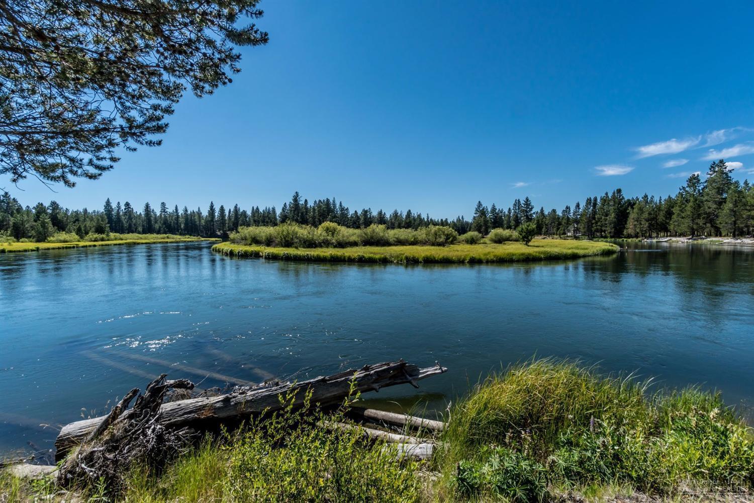 Riverfront stunner! Views with floor to ceiling windows with private view of the Deschutes River. Home is situated on a private dead end on 5.82 acres with immediate access to the river, forest and all the outdoor recreation Central Oregon is known for. Downstairs you've got an open living, dining and kitchen area with vaulted beamed ceilings and two good sized guest bedrooms and full bath. Upstairs is the private and generous primary suite with full bath and extra loft space for an office, library, or just a spot to look out at the stunning scenery. Wrap around composite decks offer great outdoor dining and entertaining space, additional RV garage/ hookups, workshop and storage provide extra room for toys and there's a private dock leading right to the river. This home is near US Forest lands, La Pine State Park, Bachelor and Sunriver. Hike, kayak, ski, fish and float all from this oasis. Radiant heat through-out & garage. Sold Furnished. Established rental history.