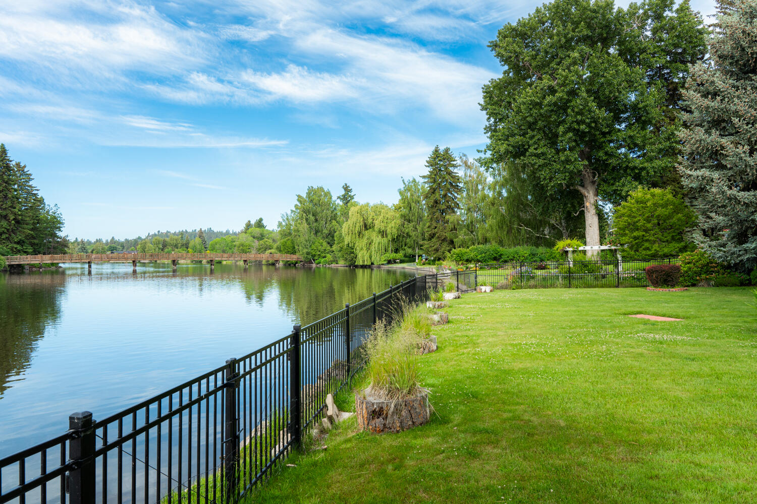 Offering the most dramatic views of coveted Mirror Pond, Drake Park and the Cascades in the distance. This secluded riverfront gem on over half an acre borders 100 feet of private Deschutes River frontage. A magical estate boasting unparalleled views of Drake Park. Currently over 5,000 +/- SF, w/multiple flex spaces, river views from most rooms, private river access & special amenities. Heated walkways & gated circular driveway transport you to a private, serene world w/park like grounds. Gracious double-height entry greets guests w/impeccable water views. Light pouring in through rooms overlooking the water on the first & second floors is brilliant. The spacious kitchen & eating areas provide ideal spaces for entertaining. French doors off the kitchen flow onto deck w/gazebo designed to blend indoor/outdoor living space. Stepping outside is like stepping into a private oasis w/professionally landscaped gardens, patios, & more.
An unparalleled Bend opportunity