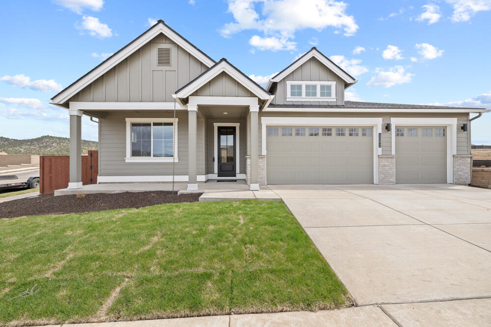 Move in ready with a gorgeous interior design palette! Beautiful new single-level home by award-winning Pahlisch Homes boasting 4-bedrooms and a 3-car garage. Featuring light-infused, spacious great room with gas fireplace & large windows open to the spacious kitchen, island eating bar, and dining area, having a tall 9' sliding door to access or view the private large covered back patio & UPGRADED rear yard landscaping. Quality finishes throughout. The spacious primary suite has a spa-style soaking tub, tiled shower & shelves plus a clear bi-pass glass door, a water closet, and large WIC. Neighborhood amenities: pool, park, playground, ½ sport's court, several green areas.  Dog-friendly community. Easy access to neighboring ~600 acres of public walking trails via paved walking path along protected wetlands. OP250 Hillmont-F. Photos of similar unit/specs vary. Model home @ 1311 NE Whistle Way, open for tours and info on Fri-Mon 11-5 pm.