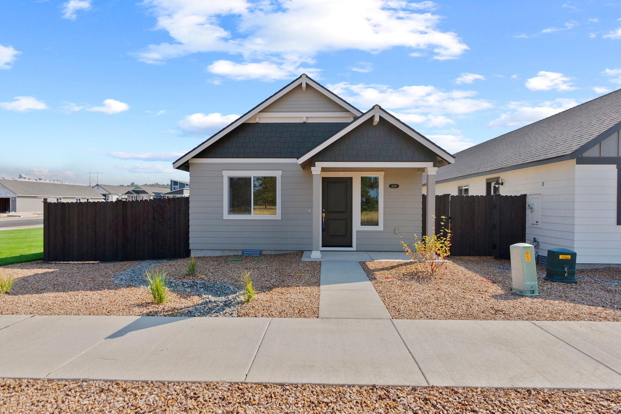 Experience townhome living reimagined for the Central Oregon lifestyle. Set on an oversized homesite, this home offers the freedom to park your RV, boat, or adventure gear right at home, a rare opportunity in townhome living. Unlike traditional designs, there are no shared living space walls with a neighbor; the only connected portion is a secure, private storage area, giving you the feel of a standalone home with the convenience of a lock-and-leave townhome. Inside, vaulted ceilings and abundant natural light create an open, airy atmosphere, while the kitchen is finished with stylish quartz countertops. An attached two-car garage adds even more room for your outdoor essentials. Designed for those who love space, privacy, and adventure, this home is truly one of a kind in Central Oregon.
