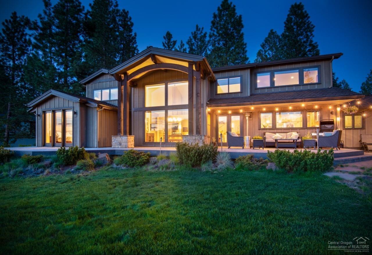 Inspired by its natural surroundings this sophisticated NW Lodge-style home reflects an elegant modern lifestyle. Completely remodeled custom home, features include spacious open and fluent Great Room concept w/ windows that bring the outdoors in from every room. 20' ceilings/wood beams, solid wood floors, knotty alder cabinetry, stone surround gas fireplace w/stone accent built-in. Gourmet island kitchen w/high-end stainless appliances/hood, matte granite counters. Master w/Ensuite on Main level, large walk-in closet w/ built-ins. Junior Suite and Den on main. Catwalk connects the 2 upper level wings of this home with bonus living area/2 bdrm w/Jack n Jill. This home makes entertaining a dream with interior/exterior surround sound, wrap-around deck, water feature, outdoor firepit and invisible fencing. Enjoy all that Bend's coveted Sunrise Village community offers including Pool walking/biking paths, Tennis & River access.