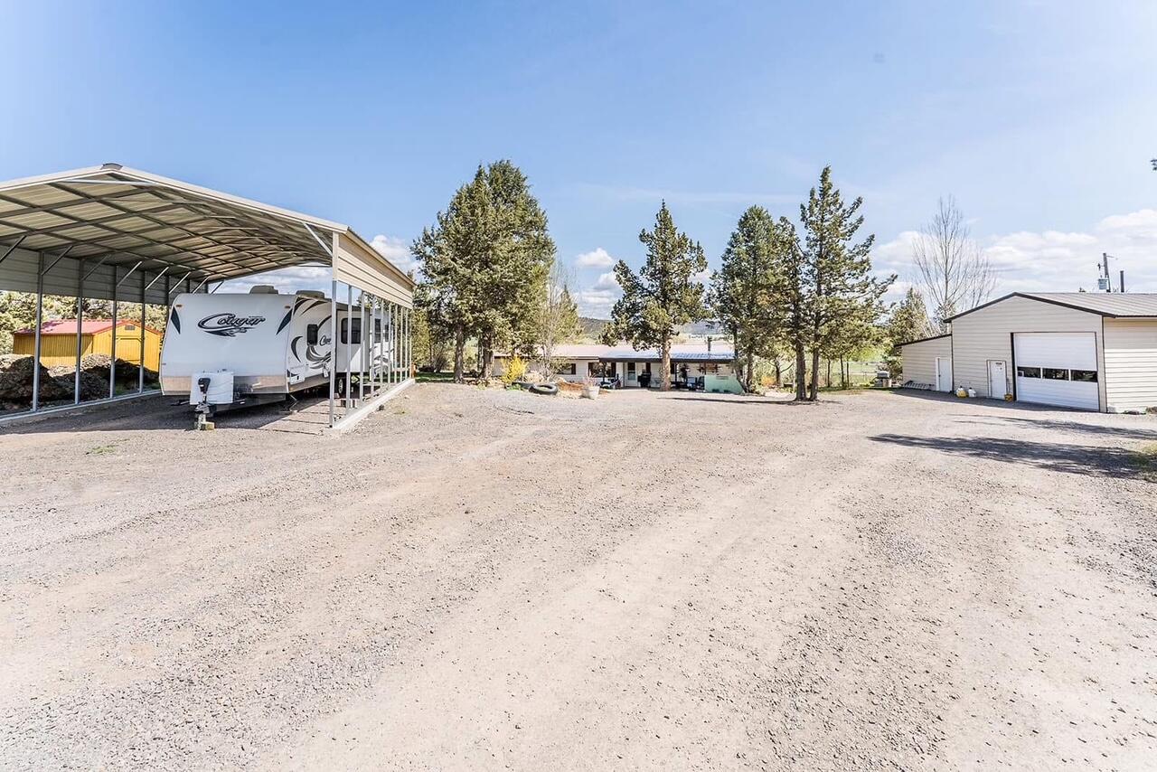 Located approximately 5 miles North of Prineville. Private setting with panoramic views of the valley and farmland. Hot Tub on spacious deck with a beautiful view. Mountain views from areas on the property. Manufactured 3 bedroom, 2 bath home on 77.72 acres with 50.2 acres of irrigation. 30x40 shop with work space, meat cooler and storage. Irrigation equipment included. Property is fenced and cross fenced. Well maintained landscape. Turn key home with Heat Pump and Central Air ready for your family to call home. Irrigated pastures have been leased in the past and lessee may be interested in continuing to lease if buyer is interested.