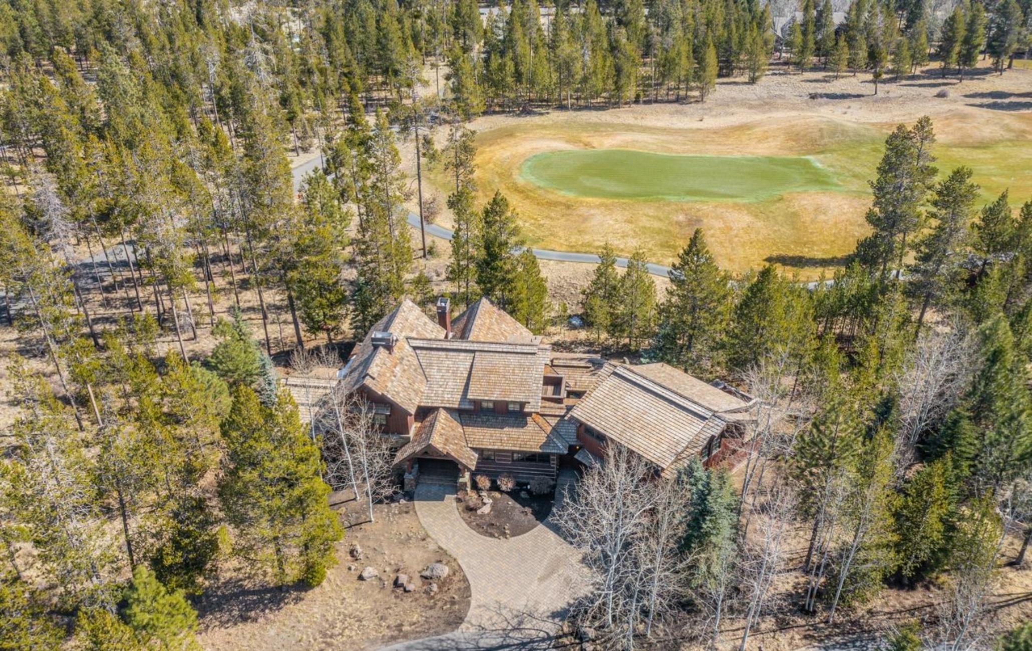 Spectacular golf and mountain views, expansive meadows, and meandering rivers await at this premier Crosswater residence. Nestled on a .49-acre lot among mature ponderosa and aspen trees, this estate is where luxury meets livability with quality craftsmanship and stunning design elements set against the beautiful backdrop of the 11th hole. With 4,326 square feet of thoughtfully appointed living space, this home offers 5-bedrooms-including two suites, multiple bonus areas, 3.5 baths, open great room, large dining area, walk-in pantry, and laundry room. Generous windows bring the outside in and create a warm and welcoming place for family and friends to gather. Gorgeous, stacked stone wood burning fireplace, vaulted ceilings with exposed log trusses, extensive stone and tilework, and wood wrapped windows add rustic charm. The timeless design showcases the renowned Pacific Northwest architectural style that celebrates the Central Oregon lifestyle. Create a legacy for your family!