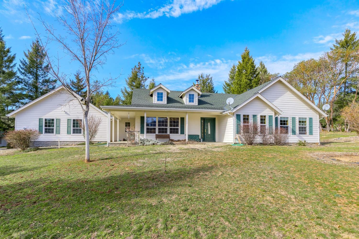 This is a WOW! Lovely home on 5 park-like acres in the desirable Springbrook Subdivision.  As you enter the property, the paved drive meanders by the beautiful pond & seasonal creek.  The home, built in 2002, features an open floor plan, grand rock fireplace adorns the living room, vaulted ceilings, 2054 sq ft, 3 bedrooms plus an office & 2 1/2 baths.  Entertain in the large kitchen with breakfast bar & oak cabinets.  The dining area looks out to the patio & back yard. Relax in the master suite, complete with vaulted ceilings, jetted tub, dual sinks, huge cultured marble shower & walk in closet.  Exterior features include attached over-sized 2-car garage, detached 15 x 25 garage, 26 x 18 metal shop, sprinkler system & beautiful mountain views! Is this YOUR new HOME?