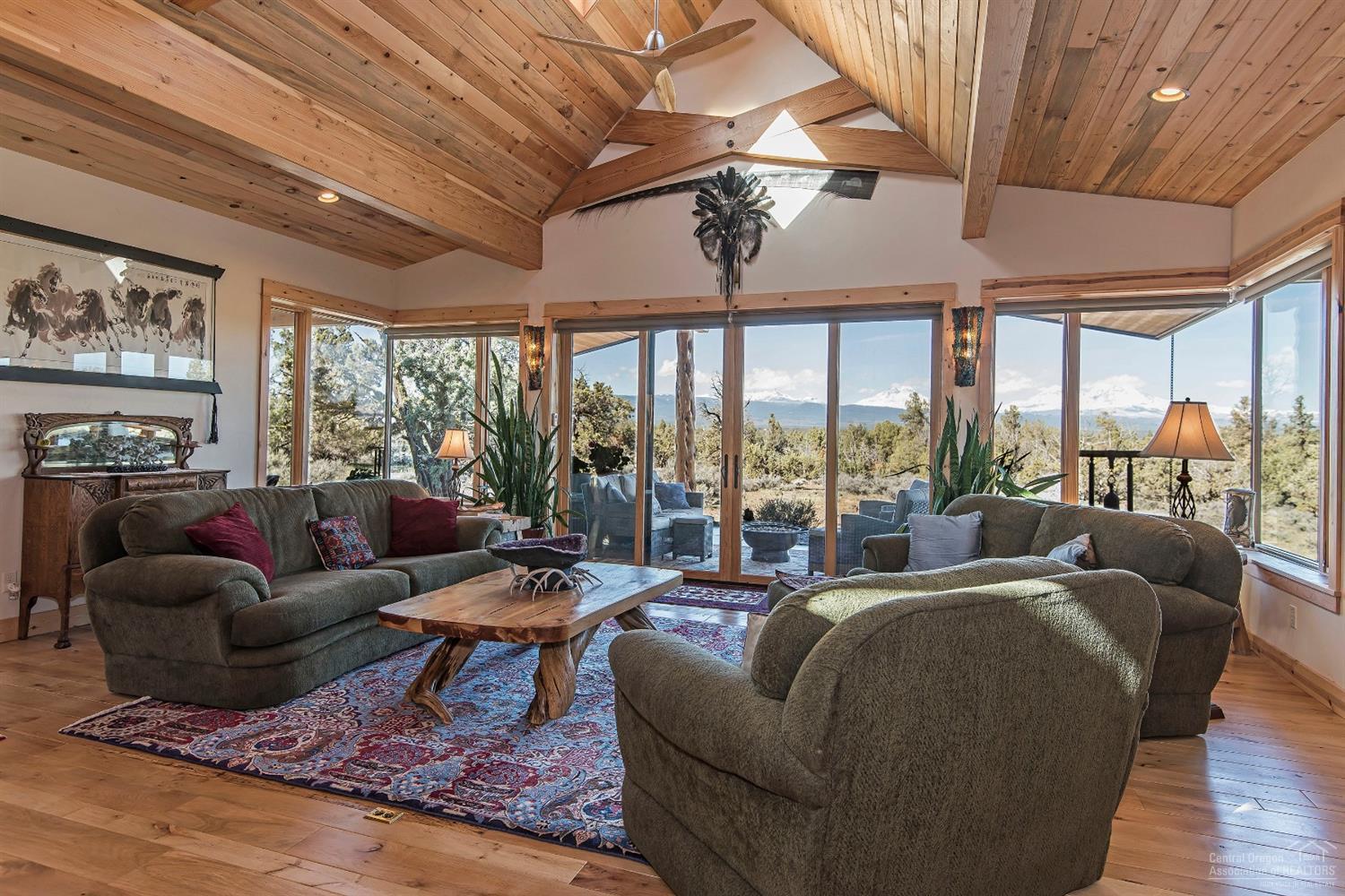 Panoramic Cascade Mountain views of the Three Sisters, Mount Washington & Three Fingered Jack include striking sunrises & sunsets over the juniper treetops. Custom built by the owner with thoughtful construction & intelligent design details, the main home includes a great room with vaulted beamed ceilings and picture windows overlooking the Cascade Mountains. Be warmed by the radiant floor heat throughout & the wood stove with a Montana Moss rock hearth. Entertain inside and out with covered outdoor living spaces. 38.76 Acres includes two residences; a 2,271 SF main house built in 2015 & 1,542 SF guest house built in 1915 (3,813 total SF of living space); large shop with an office; horse stalls, tack room & covered hay area; greenhouse & storage building. Baths include 2.5 in the main house, 1 in 1915 house, & 1 in the shop. Corral your horses and provide shelter with covered stalls and included fencing panels. Access to Cline Butte Recreational Area for hiking, horse riding and more!