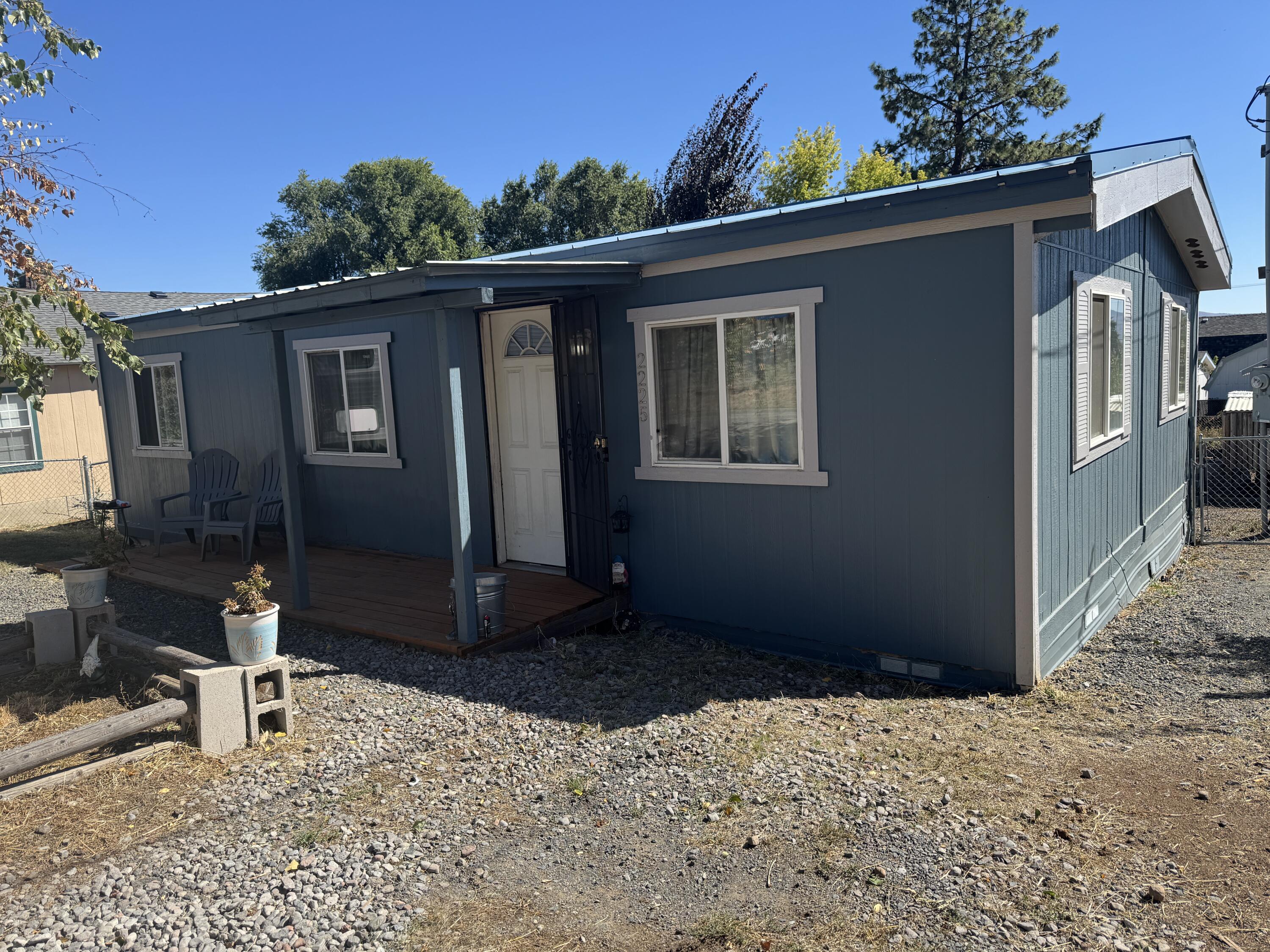 Charming & Affordable Home! Just minutes from the heart of downtown Klamath Falls, this adorable 2-bedroom, 1-bath home is packed with charm and smart updates. Step inside to find a thoughtfully designed layout that makes the most of every space, with great touches throughout. Enjoy relaxing on the inviting front porch or back patio. The fully fenced yard is a great size for gardening, pets, or simply enjoying your own private outdoor space. Awesome chicken coop & garden beds ready for you! With plenty of room for parking + toys/RV, you'll have convenience and flexibility right at home. Key features include a durable metal roof, central air, and many updates that ensure comfort and peace of mind. Whether you're starting out, downsizing, or looking for a perfect investment, this cute little home offers both charm and practicality—all just minutes from downtown!