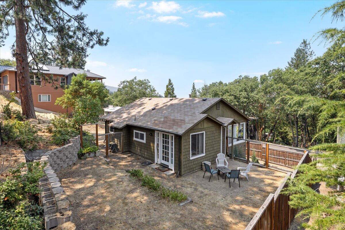 A rare opportunity in one of Ashland's most sought-after neighborhoods! Just above Southern Oregon University in the Mountain Pines Subdivision, this charming 2-bedroom, 1-bath cottage sits on a spacious .23-acre lot, ideal for building your dream home while living on site. The property is already equipped with two meter boxes, plus water and sewer lines in place, offering a head start on future development. Inside, the cottage features an open floor plan with a breakfast bar, original fir floors in the living room and one bedroom, and laminate wood flooring in the second bedroom and kitchen. Large picture windows bring in abundant natural light, equipped with a mini-split heating and cooling system while the daylight unfinished basement provides ample storage and workspace. Enjoy the peaceful outdoor space, beautiful mountain and sunset views, and a quiet setting surrounded by highly desirable homes, just minutes from downtown, SOU and Ashland's trail system!