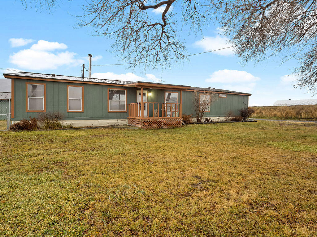 Charming countryside 4-bedroom, 2-bath home on 6 irrigated acres with KID Water District rights, conveniently located close to town. The property is fully fenced and cross-fenced, ideal for animals or hobby farming. Features include a metal roof, Blaze King wood stove, low property taxes, and a shed for additional storage. Inside, enjoy a spacious living room, generously sized bedrooms, and a private primary bathroom. A perfect blend of rural living with nearby amenities.