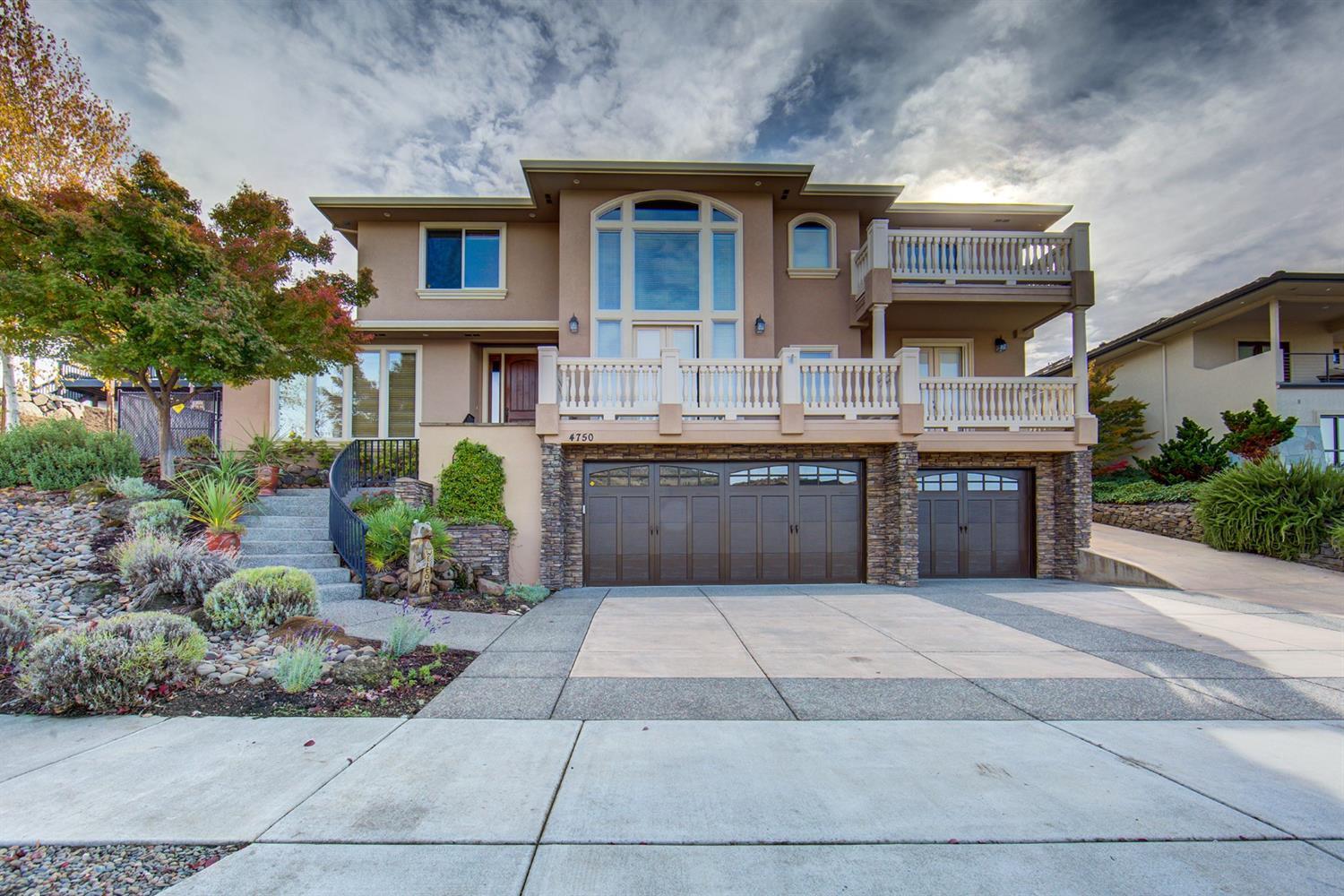 Need RV parking x2, huge garage with storage, luxury amenities and views? This 3524 SQFT house is the one! The 2,200+ SQFT garage/shop has room to store 8+ vehicles. Interior upgrades include: custom flooring, insulated interior walls, dual zone HVAC, whole house network and sound system. The kitchen boasts granite tops, deluxe cabinetry with soft close drawers, recessed and drop lighting, stainless appliances, center island with eating bar, tile backsplash and garden ledge. The master suite has coffered ceilings, double door entry and a private balcony with city and mountain views. The master bath has a large soaking tub, dual sink vanity, walk- in tile shower and frosted glass sliding doors. Outside are multiple balconies (front and back). The backyard has a massive covered concrete area has room for covered seating, hot-tub and BBQ hookups for year-round enjoyment. The landscaping is immaculate, with rock waterfall, irrigated raised garden beds and beautifully terraced grass