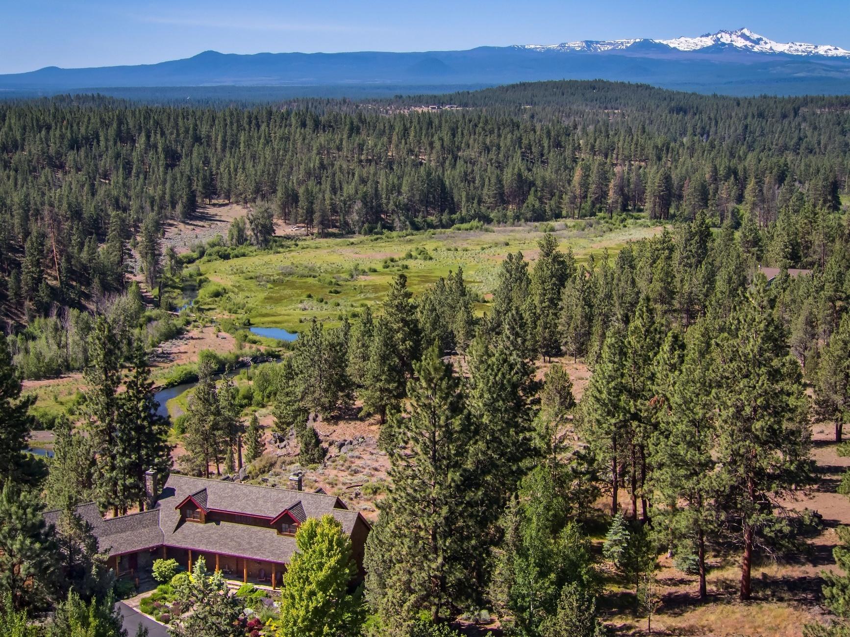 This unique custom home and property has unobstructed, stunning views of Cascade Mountain and Whychus Creek. 18.15 acres in the pine trees with landscaped yard, secret garden overlooking the canyon. Elegant 1920's Camp Sherman Style Home is 2948 sq ft, 3 bedrooms, 2.5 bathrooms, chef's kitchen with Wolf gas cooktop, 2 ovens, pantries, chestnut wood floors, dining room with views, nook, living room with stone fireplace, main floor master suite, utility room attached 2 car garage. Outdoor living is exceptional with covered porch and deck. Property includes: old fashioned designed barn with 2 stalls, full length loafing shed, wash stall, heated tack room, studio/office with bathroom, paddocks are fenced/cross fenced, ready for horses, outdoor arena, approximately 6 minutes on horseback on a quiet road to National Forest and riding trails. Paved Driveway. Neighborhood has 12 acre common area with picnic area on the creek. Property is about 7 minutes from downtown Sisters.