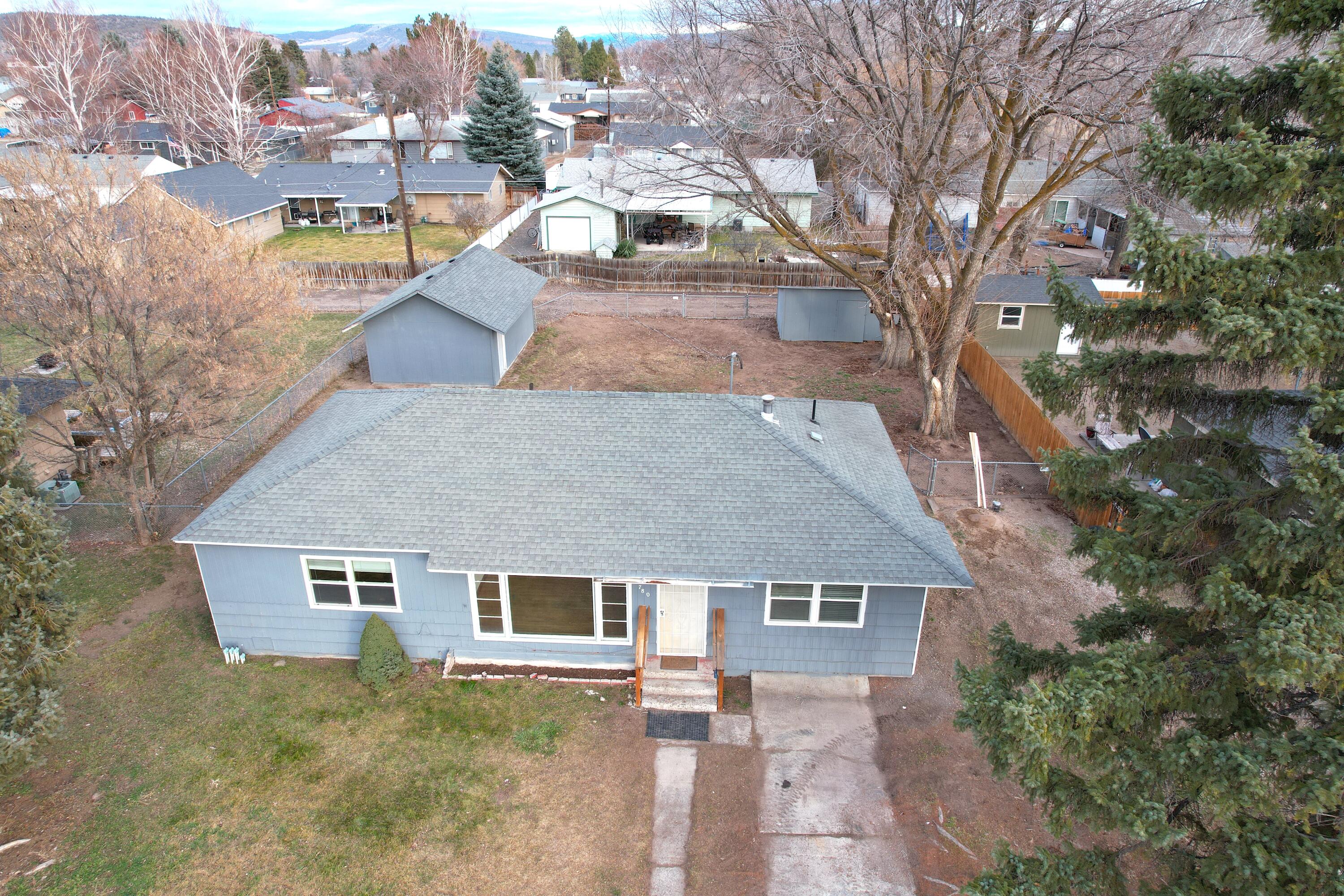 Check out this 3 bedroom 2 bathroom home with original hardwood floors!! This 1248 sqft home has some very nice updates! Kitchen has been remodeled with new counter tops, appliances, and flooring. The original hardwood floors have been refinished, and new paint on the inside and outside of the home. A large deck overlooks the fenced and shaded back yard. Work on your projects in the 16'x24' shop, and store your toys in the 10'x20' storage shed! Gravel RV parking on the side of the home, and alley access! Call today for a showing!