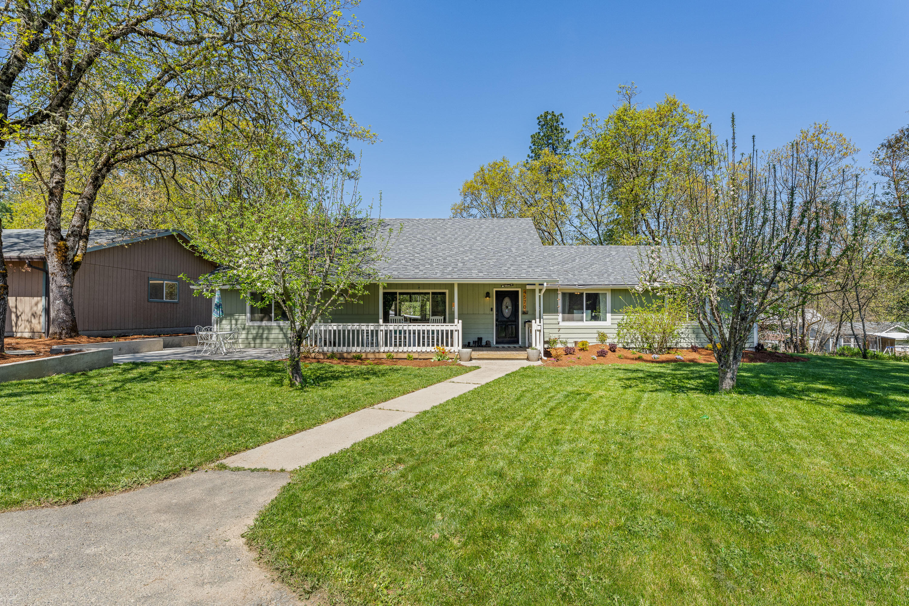 Sweet country living close to town! Lots to offer here with a single level 3 bedroom (easily 4 bedroom with current office), 2 bath upgraded and updated house with covered front porch and easy flowing open
floorplan. Kitchen features granite counters, farmhouse sink and eating bar. Split floorplan and office off of the living room. Private patio in the rear for 
barbecues and family gatherings on the 4.88 level acre parcel. There is a 4+ car finished garage as well as smaller shop AND A VERY BIG barn with metal roof. Car collectors, horse facility, home business storage needs take note! Located very close to town.  Won't last long- first time offered!