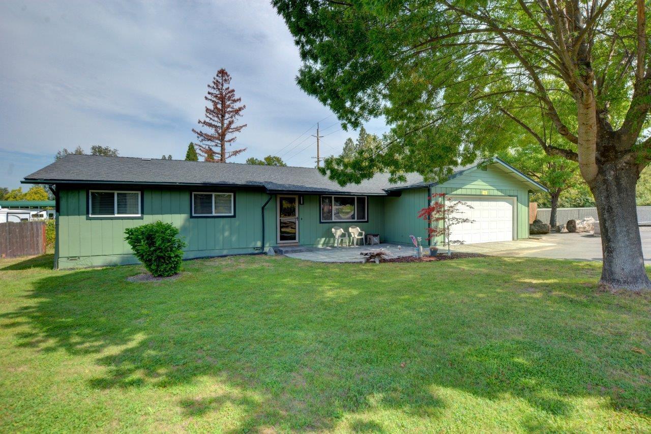 Beautifully updated 3-bedroom, 2-bath home on .58 acres with 1,556 sq ft of living space! Inside, you'll find a spacious living room with cam lighting, a family room, and a fully remodeled kitchen featuring quartz counters, stainless steel appliances, wall oven, gas stove, motion-sensor faucet, breakfast bar, and abundant cabinets. Enjoy waterproof flooring throughout, travertine tile, ceiling fans in every bedroom, and a certified wood-burning fireplace.
The main suite offers patio access and a walk-in tile shower, while the guest bath includes a step-in tile shower. Outdoors boasts large covered decks, fruit trees, 2 sheds, and a shop with 110V/220V power. Additional perks: new ductwork, finished 2-car garage, RV hookups & dump.