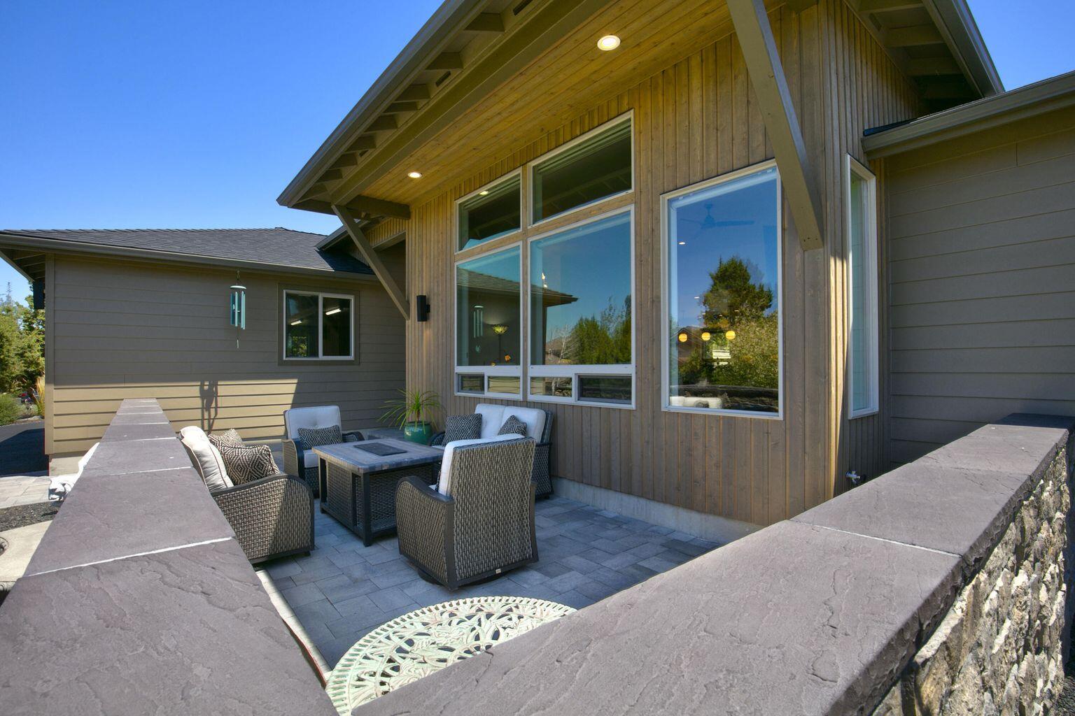 This stunning Northwest Contemporary home, situated on a quiet cul-de-sac in the award-winning Eagle Crest Resort offers a luxurious and amenity-rich living experience in the picturesque Central Oregon landscape! Ownership includes fitness centers, golf courses, pickleball and tennis courts, swimming pools, restaurants, trails, and more.. This single-level home features a stunning open-concept floor plan, and at the heart of the great room is a cozy gas fireplace, custom built-in cabinetry, & floating shelves, while at the center of the bright, open kitchen is a spacious island, perfect for casual entertaining. Seamless functional living space and modern finishes are found throughout the house. Enjoy the outdoors and take in the stunning sunsets from the expansive paver patio in the back or the cozy courtyard space in the front with impressive views of the Cascade Mountains. Don't miss this magnificent dream home!