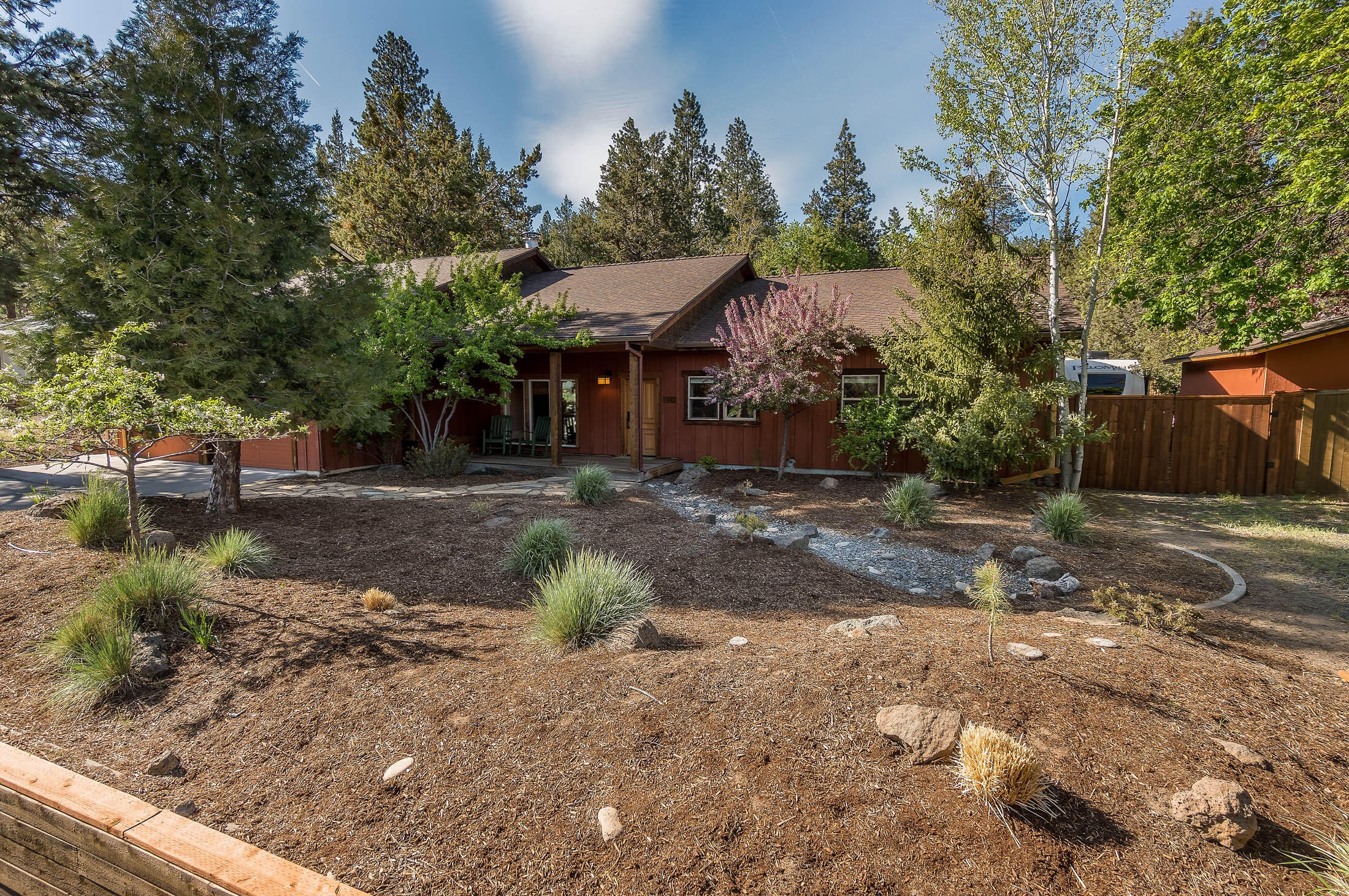 Welcome home to this enchanting single level residence on a beautifully treed .29-acre lot in a desirable NW Bend community that puts you in the center of it all! Private, fully fenced backyard is ideal for soaking in the sunshine or gathering under the stars after a day of play. 2,266 sq. ft. of well-designed living space provides for multi-generational living or income potential, with 4-bedrooms, including a lock-off suite with kitchenette, full bath, and private access, and an additional bonus room. Hardwood floors, vaulted ceilings, skylights, wood burning fireplace, and abundant windows provide warmth and character. Attached 2-car garage has plenty of storage and a laundry area. An additional detached 2-car garage is well suited for hobbies and toys--and there is even RV parking. Located just minutes from downtown, NWX, Shevlin Park trails, and the Old Mill. Whether you are looking for an investment property or full-time residence, this home lives the Bend lifestyle in a big way!