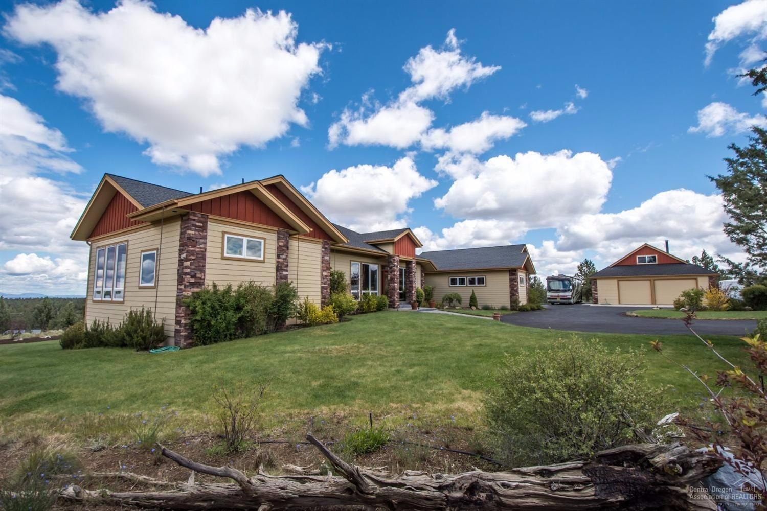 The privacy of the country, yet city close; this extraordinary single story 4,220 sq. ft., 4 bedroom, 3 bath luxury property is situated on a 4.86 acre lot with 180 degree views of the Cascades; like new-completely redesigned & remodeled in 2010; exotic Indonesian cherry solid t&g flooring; kitchen with solid raised panel American cherry cabinets and solid granite counters; radiant floor heating; Trek back deck; large detached shop with bonus room and full bath; gated and fully fenced; borders BLM land.