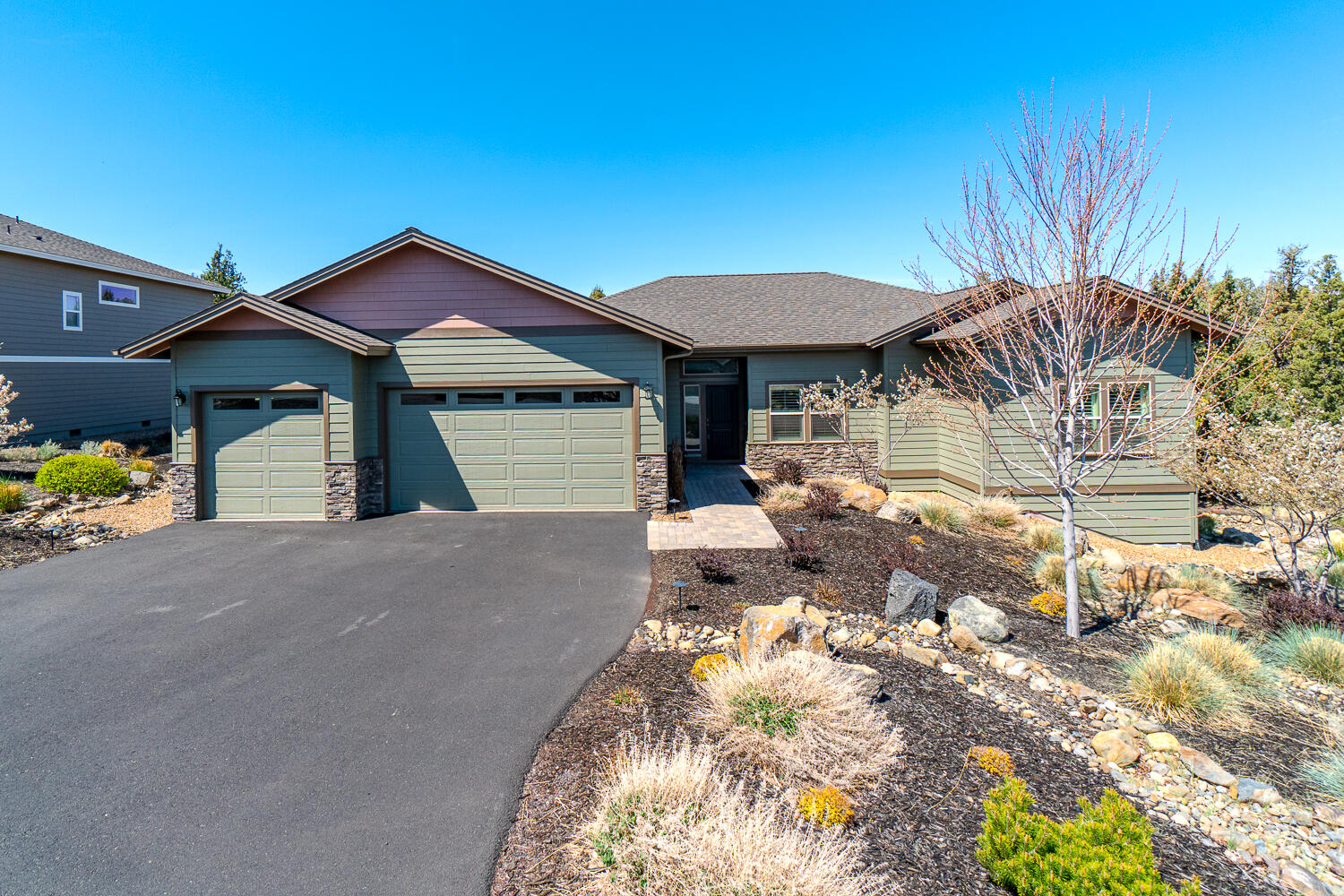 Gracious living awaits you in this lovely, single level home located in Eagle Crest Resort. A welcoming foyer features a distinctive office/den space off to the side as you enter. This home is a entertainers dream with a flowing open-concept floor plan and 12' ceilings. A stone fireplace and engineered hardwood floors lend an elegant warmth to the home. Stunning custom cabinetry in the kitchen is highlighted by a large island breakfast bar, solid surface counter tops, stainless appliances and a pantry. The dining room features a door that leads to a big stone deck overlooking a quiet green space and low maintenance yard; you'll have plenty of room for friends and family to gather. The main bedroom suite is a peaceful retreat with private bath and walk-in closet. Two additional bedrooms share a spacious full bathroom. An over-sized garage completes the package. Eagle Crest is home to three 18 hole golf courses, three sports centers, an 18 hole putting course, a spa, and miles of trails.
