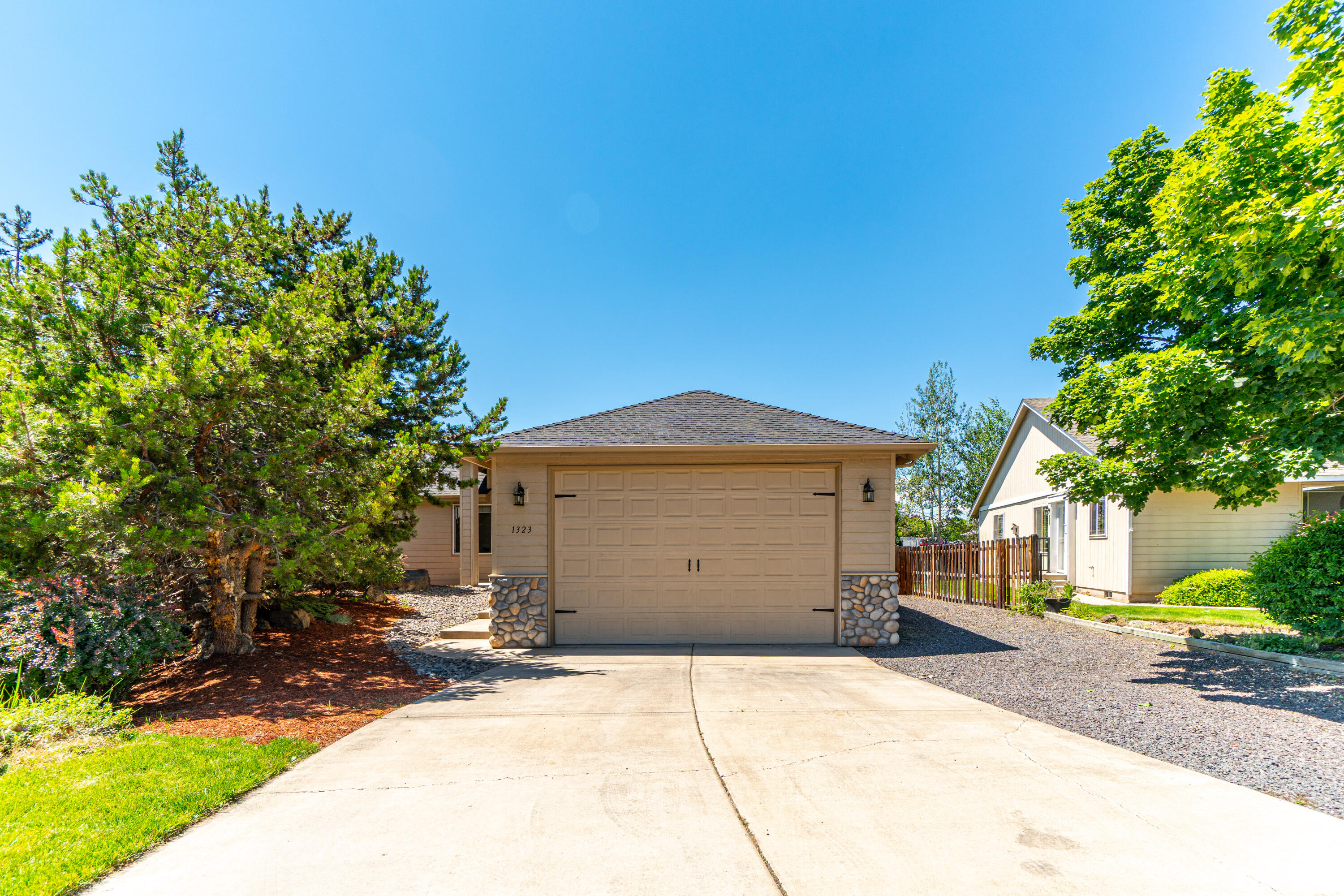 Modern and updated turn-key single-level home in NE Bend with an active STR Permit. High vaulted ceilings and natural light greet you upon entry into the great room with a gas fireplace & dining area off the kitchen. New SS appliances and LVP tile flooring in the kitchen, bathrooms, and laundry rooms. New modern baseboard trim, window casing, fresh interior paint, and updated lighting & fixtures throughout the interior/exterior all complemented by beautiful hardwood flooring in the living room and bedrooms.  Nice sized primary suite with a walk in closet and full bathroom. A generous sized laundry room provides direct access to your HUGE 572 sq/ft garage with built in storage and high ceilings for all your toys.  Central vac to help with allergy season, A/C, & front sprinkler system. Enjoy the back patio and fully fenced back yard for your furry friends. Awesome location close to St. Charles, Costco, On Tap, Pilot Butte, and many parks. This is a great home and investment opportunity!