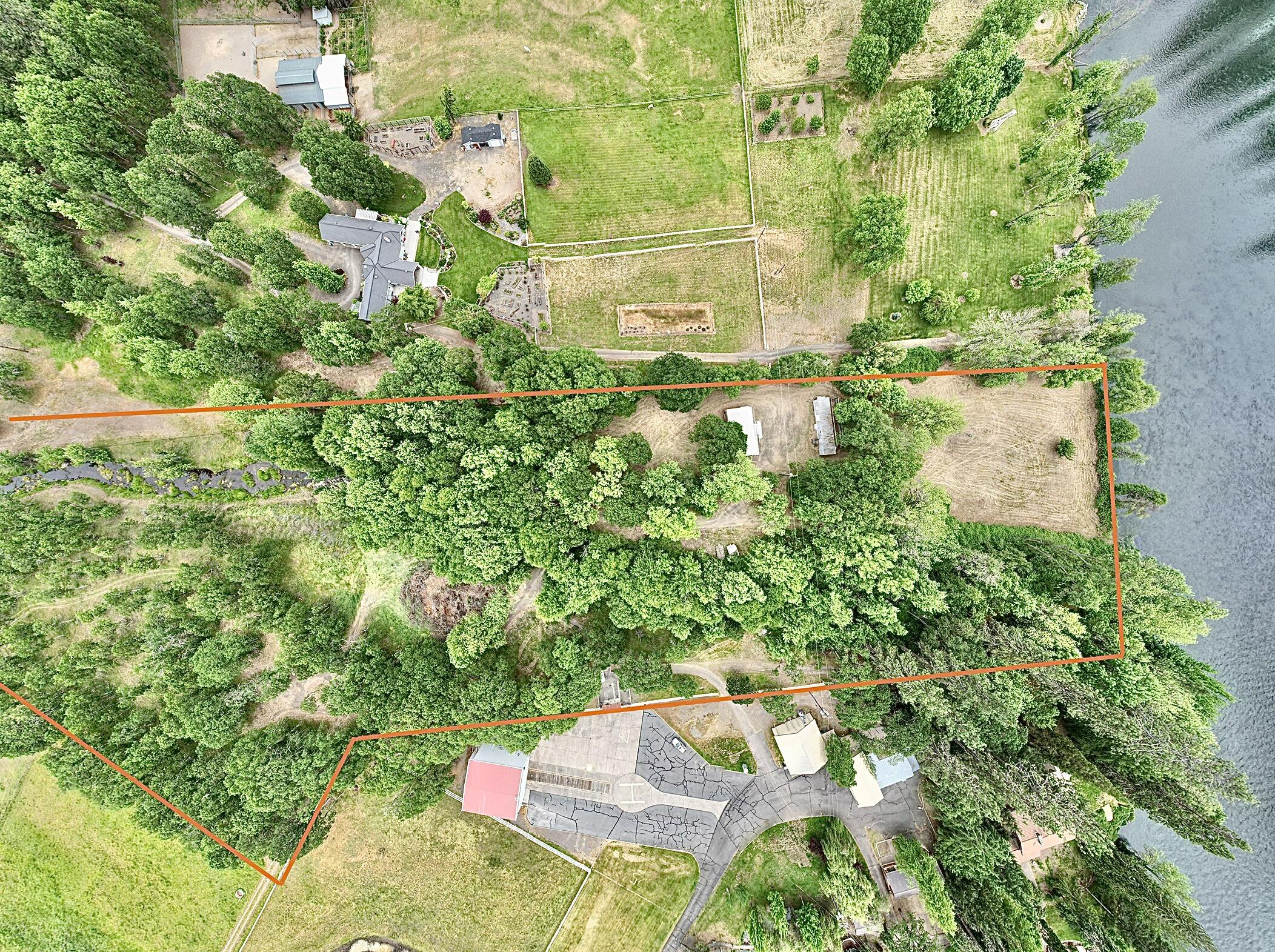Prestigious 10.02-acre Rogue River Front property on Modoc Road with a year-round creek, a 1200 sq ft shop and a Mobile home with well, power and septic from the original construction of 1973. Zoned EFU with irrigation rights from the Rogue River. With a view of the Rogue River and a 128-acre natural land preservation from your front yard. Local to the Medford Airport for air travel. Come and build your dream home and live on the Rogue River. Enjoy your acreage of privacy, fishing and rafting on the Rogue River, hiking Table Rock, boating at Lake of the Woods and Lost Creek Lake. Additional private road access may be obtained. This property can also be purchased in conjunction with a connecting 10.89-acre and EFU-zoned land with irrigation rights (see listing for 12240 Modoc Road #B). Realtor must accompany all potential buyers for access. Buyer to perform due diligence for construction and use of the property.