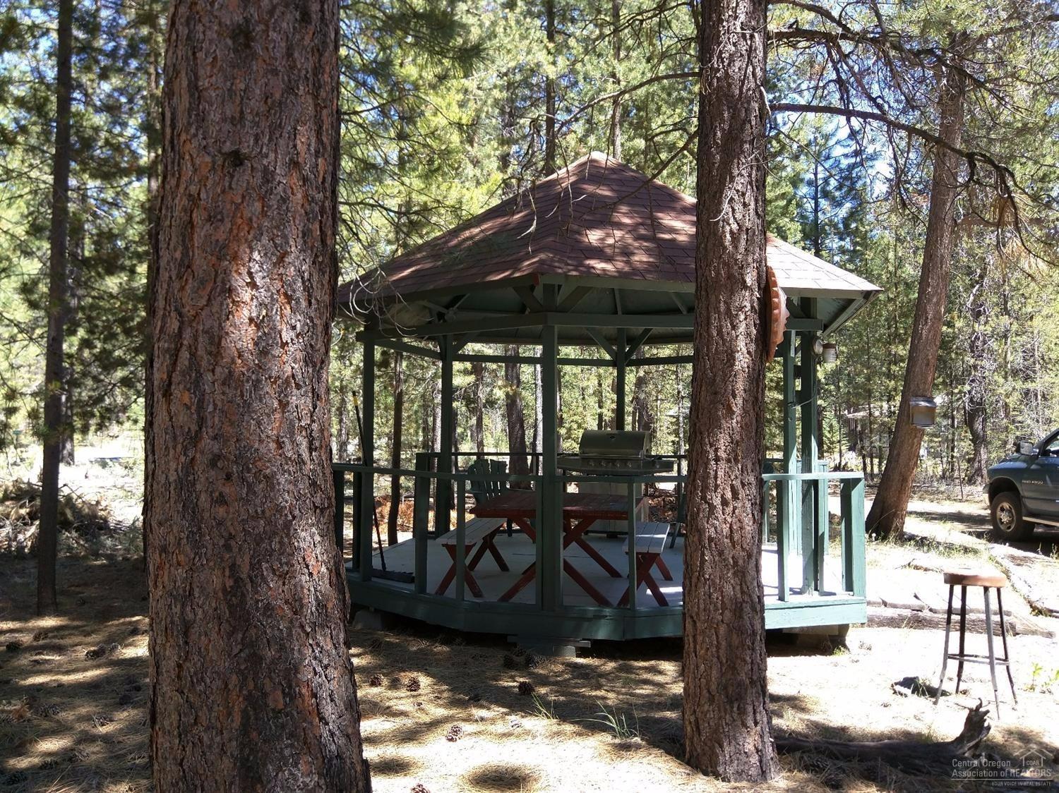 Peace and tranquility on this 1.24 acre nicely treed lot with back 1/4 acre fenced. New Metal Roof 2015, New Interior Paint, New Carpet, New Flooring, New Fridge,Dishwasher, Water Fixtures, and new Range/oven are featured in this super clean gorgeous home in the pines. Certified Woodstove. Lrg Shower In Mstr Bdrm. Alder Cabinets Thruout. Breakfast Bar, many Upgrades. 10.5Ft High ceilings. Rv Pole Barn W/12x30 insul sheetrck shop W/220 & Water. GAZEBO!! W/6x6 basemt which Houses The well. Don't Miss!