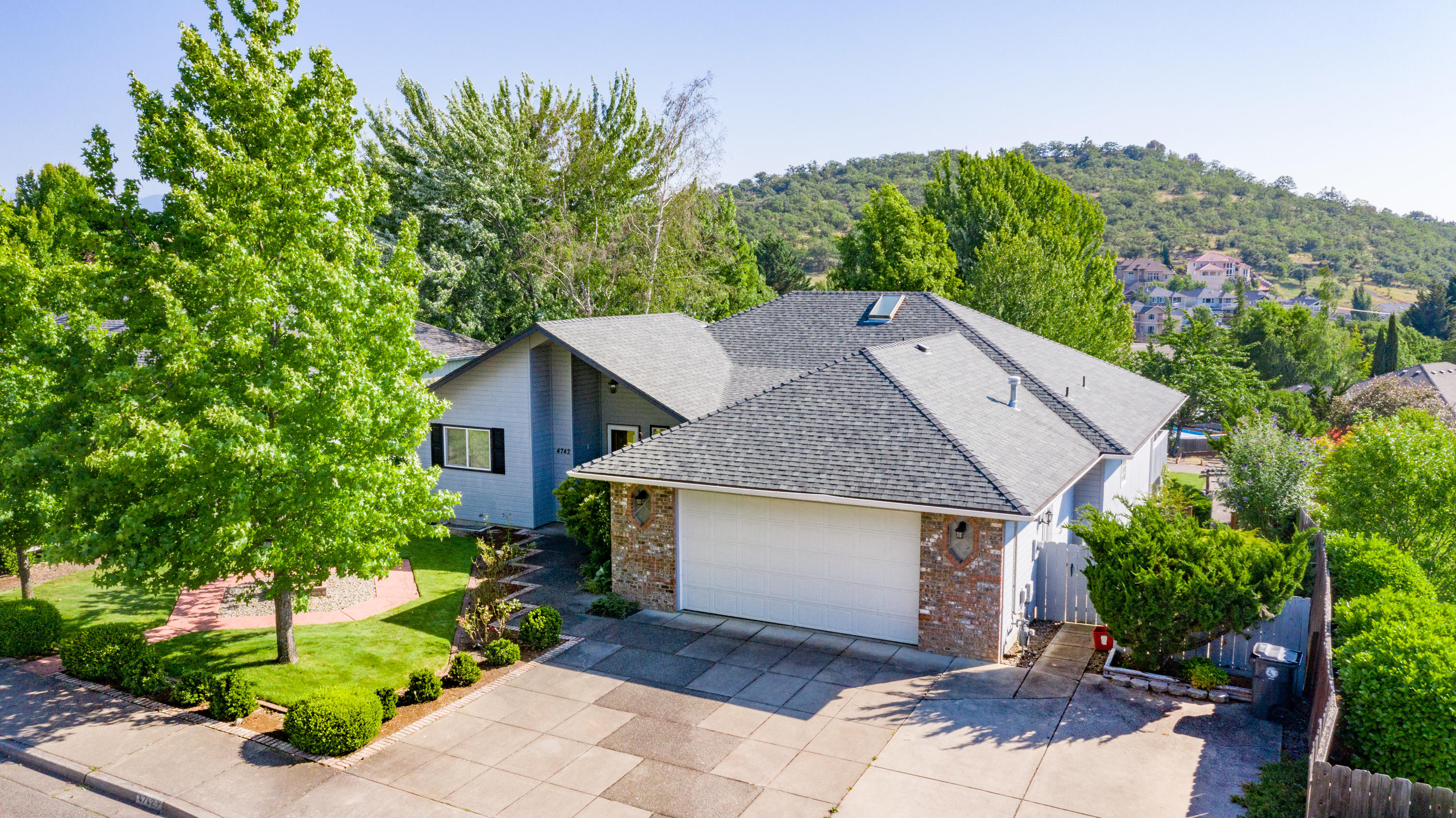 Well designed single level home on a large lot in a quiet, well established East Medford neighborhood. Great curb appeal with beautiful mature landscaped front yard. Covered front porch leads to a spacious Brazilian granite entryway. Living room has coffered ceilings, a double sided gas fireplace and large windows to enjoy the views and capture natural light. Large kitchen open to the dining area has Italian tile, newer stainless steel appliances and great countertop work space. Slider leads out to a large deck overlooking the beautiful backyard with Koi Pond, patios various mature plantings and expansive views of the mountains afar. Great separation of the bedrooms, master bedroom suite on one side with soaking tub, shower, dual vanities and walk-in closet. Two additional bedrooms and a shared bathroom are on the other side of the home. Lots of storage space! This is a great house awaiting your personal touches!