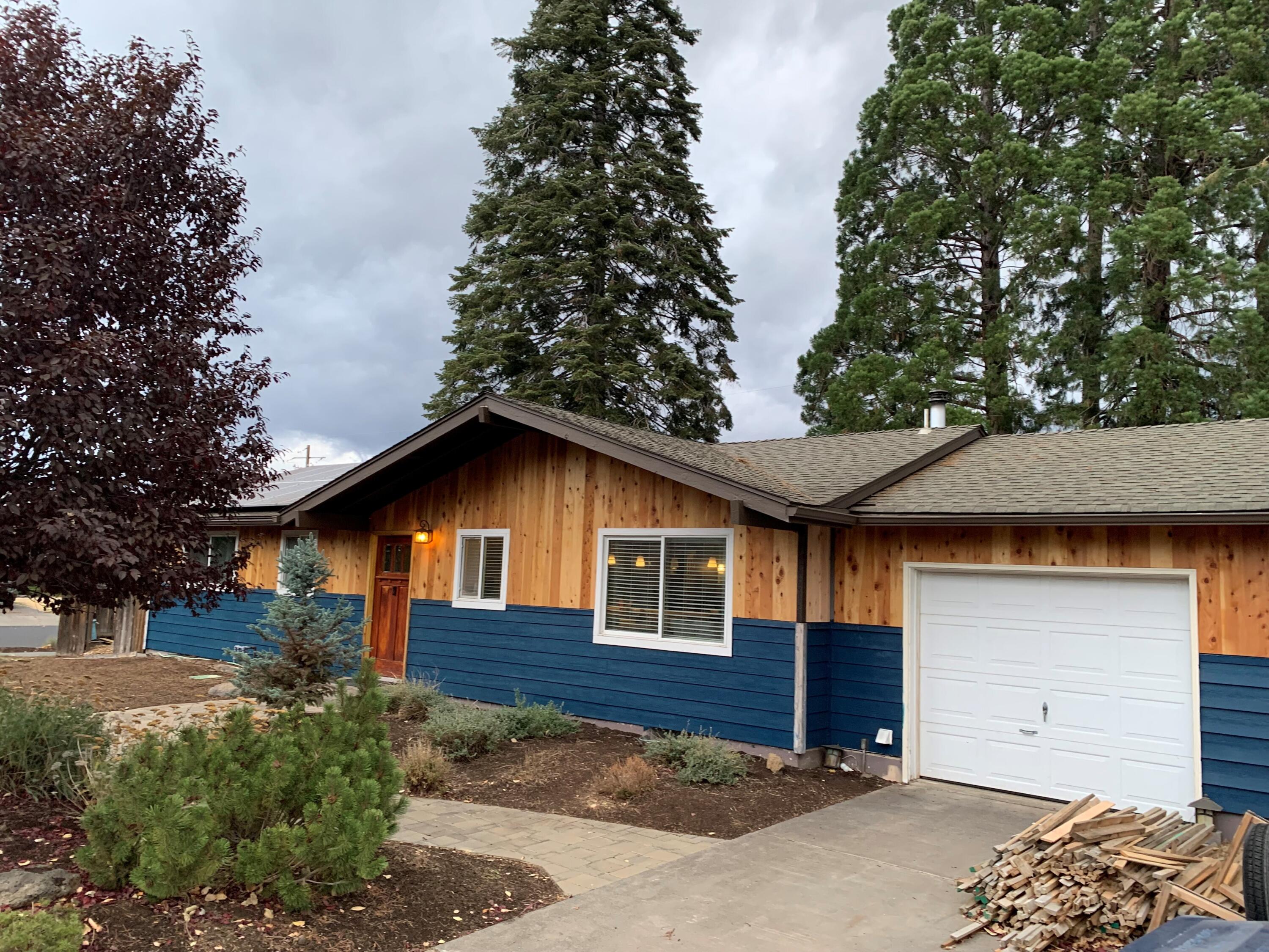 Cute single level on a large corner lot on a quiet street in midtown. This 4 bedroom, 2 bath home is just a few blocks from popular Hollinshead Park, Pilot Butte Park, The Midtown Yacht Club food trucks and just a few minutes drive to downtown Bend and the Deschutes River Trail off Revere Ave. The kitchen has been updated and there is a newer wood burning stove that is an efficient source of heat. The exterior looks great with new paint, cedar siding and new landscaping. There are solar panels that keep the electricity bill low year round, raised garden beds with irrigation and a large, fenced backyard with a paver patio is ready for your personal touches. The attached single car garage has been converted into storage and a workshop area. Could be converted back. This is a great starter home or a perfect investment property!