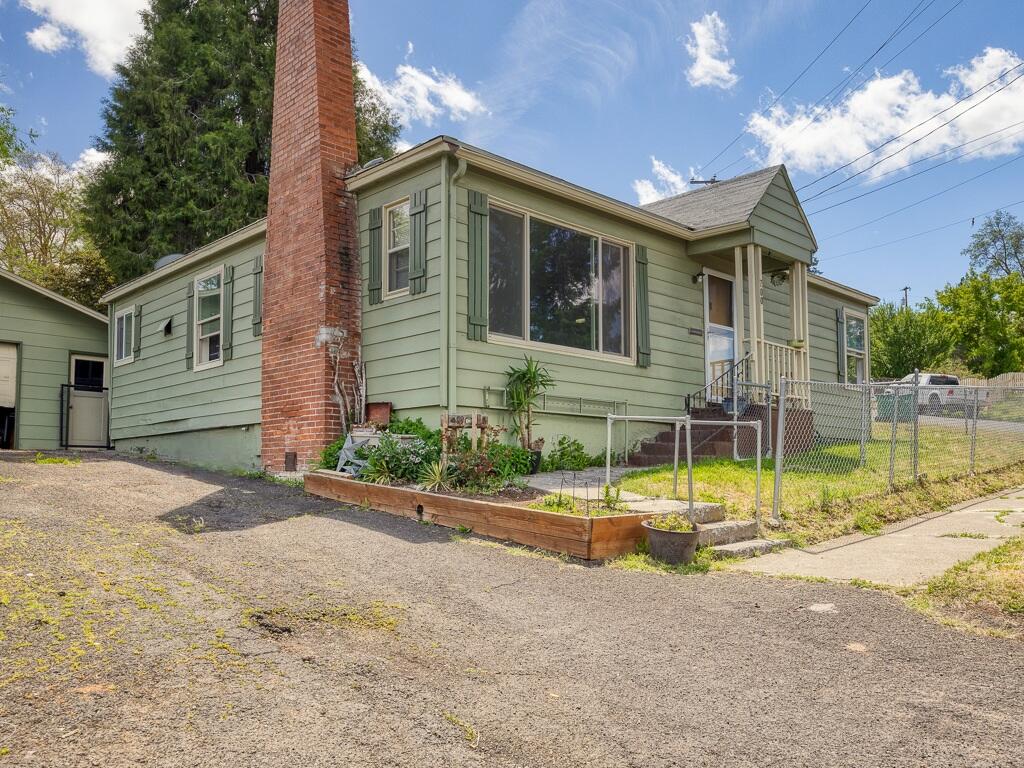 Welcome to this striking 1940's home, a delightful blend of vintage character and modern comfort. This cozy property offers 3-bedrooms, 1-bathroom, 2 car garage, and a fully fenced corner lot. Upon stepping inside you will find original hardwood floors that have been lovingly maintained, plenty of natural light spilling into the living area, a wood burning fireplace, lovely tile shower/bathtub combo, and fresh interior paint. 
Outside enjoy the evenings on the large private back patio, or spend some time in the sun while you utilize the spacious yard for gardening or relaxation. Call today, your dream home is closer than you think.