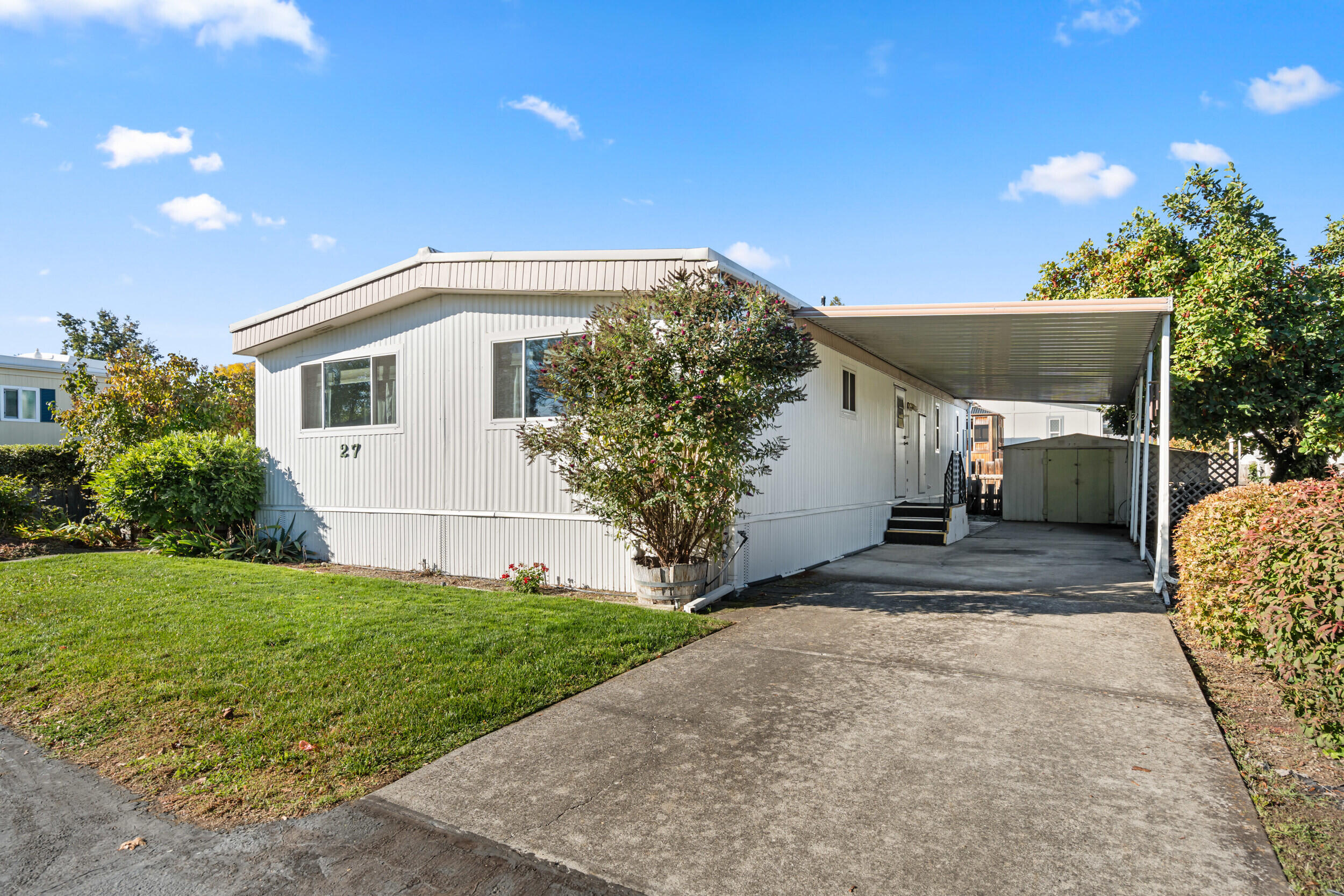 Move-in ready and well-maintained 2 bed, 2 bath double-wide in Candlewood Park, a desirable 55+ community in Talent. Enjoy a spacious kitchen with plenty of storage and counter space, recently painted exterior, and included appliances: washer, dryer, range, dishwasher, and refrigerator. The private, low-maintenance fenced yard features water-wise landscaping and TID well access for gardening. Relax on the large deck, use the storage shed, and park easily under the covered carport. Candlewood Park offers a quiet, friendly setting close to public transit and shopping, with community green space, a shared garden, and optional free RV storage.