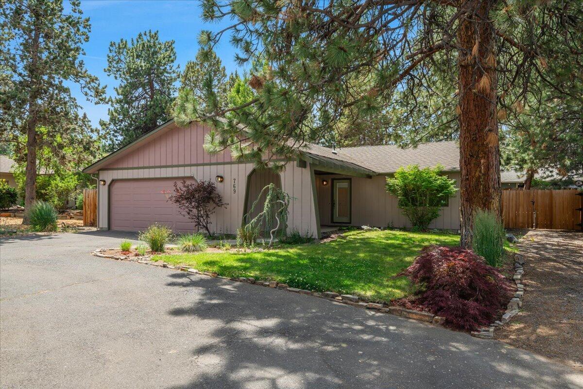 This light-filled single-level ranch in SE Bend's Larkspur neighborhood sits on a private .22-acre lot at the end of a quiet cul-de-sac. With 1,751 sq ft (including a 231 sq ft permitted addition in 2023), the home now features expanded living and dining areas—ideal for entertaining and everyday comfort.  Enjoy vaulted ceilings, hardwood floors, four skylights, and generous natural light throughout. Recent updates include a newer roof, fresh interior paint, and brand-new carpet, making this home truly move-in ready.  The oversized 2-car garage, circular driveway, and dedicated RV parking offer convenience and flexibility. The fully fenced back yard is perfect for outdoor living, complete with mature pines and a built-in fire pit.  Located minutes from the Larkspur Center, parks, and trail systems, this home blends comfort, functionality, and location in one of Bend's most beloved neighborhoods.
