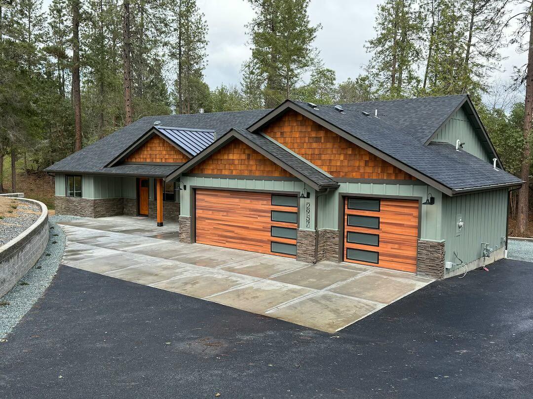 Brand new home on a private street, set on over two acres of peaceful seclusion, yet only a mile from shopping and the medical center. Surrounded by serenity, this home features hardwood and tile floors, cedar accents, and tongue-and-groove with exposed beam ceilings. The spacious kitchen is perfect for entertaining, and the dramatic floor-to-ceiling stone fireplace anchors the living area. High-efficiency gas heat and water heater add comfort and value. With countless upgrades and custom details throughout, this rare retreat combines privacy, quality, and convenience in one perfect package.