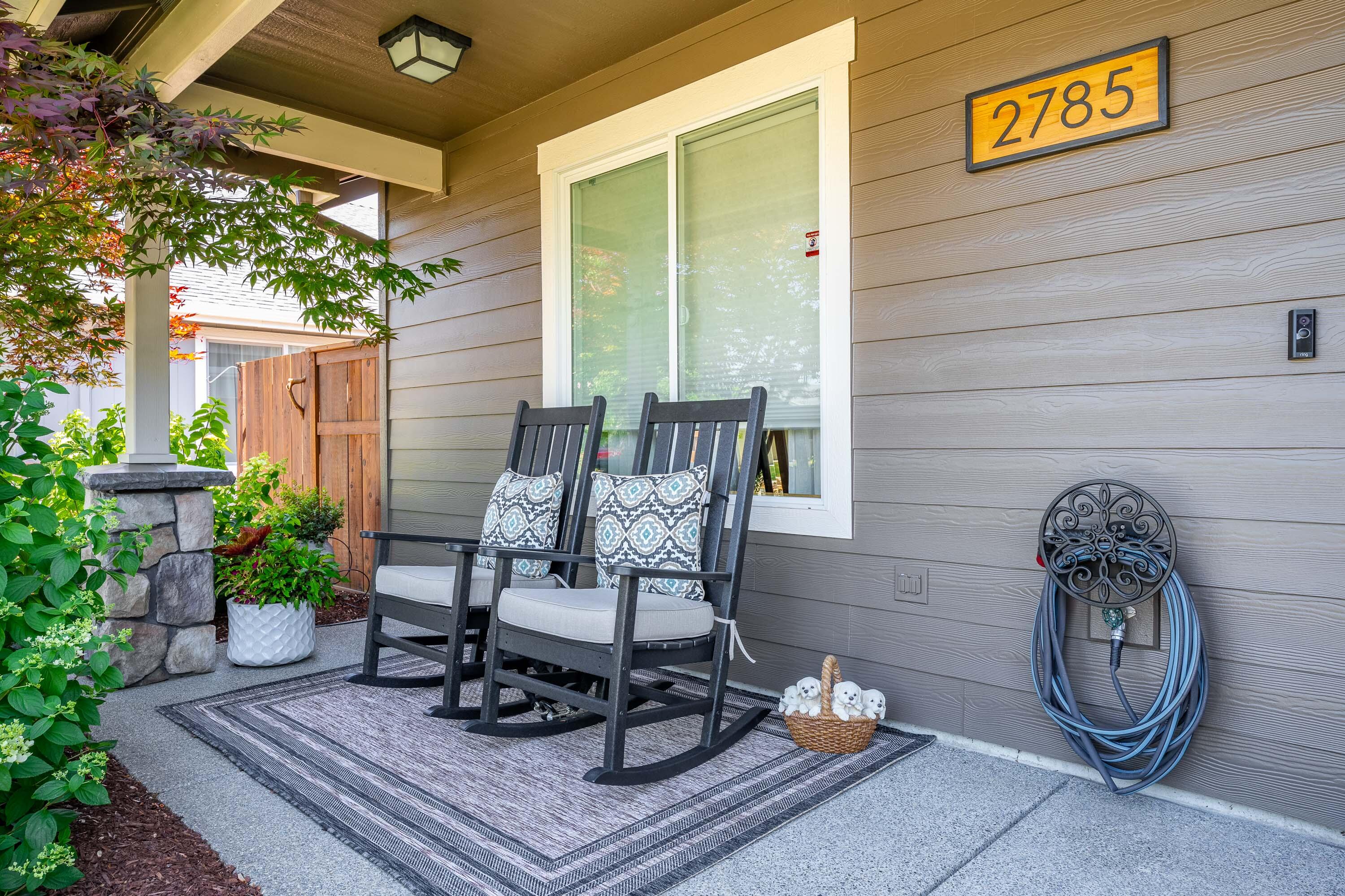 From the moment you step onto the charming front porch you know you are in for a treat with this beautiful home in a great neighborhood. Once inside, you'll find the open-concept design flows seamlessly into the living and dining areas perfect for entertaining.  The stunning kitchen features newer custom cherry wood cabinets, stainless steel appliances, granite counters and an island with breakfast bar.  Featuring a spacious master suite with  dual sinks and a good sized walk in closet as well as two comfortable guest bedrooms, one with a walk in closet and a well-appointed guest bathroom.  Step out back and  relax on the covered porch complete with ceiling fans and take in the phenomenal yard that backs to a private drive that leads to the garage and 5 acre protected wetland area—offering peace, privacy, and abundant wildlife viewing year-round. A true gem that combines style, comfort, and nature.