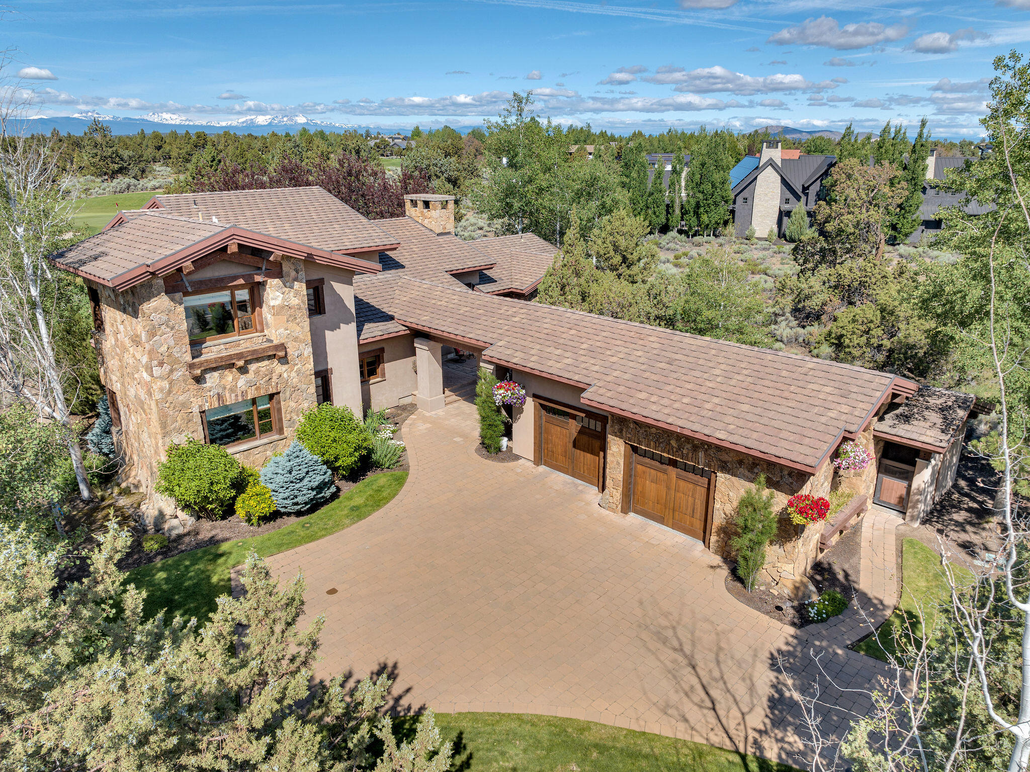 OWNER CARRY OPTION - ask for details! Located in the gated estates of Juniper Preserve, this extraordinary home offers ultimate privacy with stunning views of the Cascade Mountains and the 8th green and lake of Pronghorn's Nicklaus course. A serene water feature guides you to the grand entry, where soaring ceilings and the Montana Moss stone fireplace define the great room. The chef's kitchen impresses with a wet bar, wine fridges, island seating, and seamless flow to the covered patio with built-in BBQ, fire pit, and extended seating. The main-level primary suite features a spa-like bath with soaking tub, dual vanities, and a dream closet. A separate main-level guest suite offers ideal privacy, while upstairs boasts a stylish bonus room with wet bar, private balcony, home office, and additional guest suite. Enjoy world-class golf, pickleball, pools, dining, and more in Central Oregon's premier resort community.