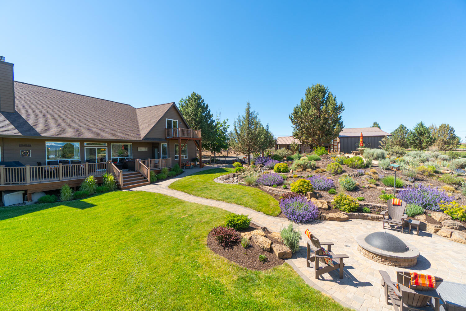 Stunning, sweeping mountain views from Mt. Bachelor to Mt. Hood. Private and peaceful! Just under 10 acres, irrigated, fenced/x-fenced, shelters, multiple barns, potting shed and pond. Gardener's delight with extensive, lavish landscaping and flower beds. Bubbling waterfall feature and built-in propane firepit. , plus expansive decks and patios to enjoy the exquisite views! Gorgeous, updated 3300sf home boasts vaulted ceilings and open, great room style floor plan, perfect for hosting gatherings! Kitchen and Primary Suite have been extensively remodeled and thoughtfully updated with high-end finishes throughout. 3 full bathrooms, 4 bedrooms plus an office, loft and bonus room offer plenty of options for entertaining. Radiant heated flooring in primary bath and kitchen. Make this little slice of heaven yours today! Only a few minutes to downtown Bend, Oregon - one of the most sought after destination cities in the U.S.