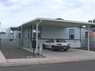 Newer Adult Park. Nice wide street and newer homes. Home has vaulted ceiling with a great open living room-kitchen combination. Eating and work center in kitchen plus a dining area. Large utility room. Split floor plan for bedrooms. Large wooden storage building. Home is well maintained and shows like new. Carport is side by side with room for two cars. Yard has chain link fencing.