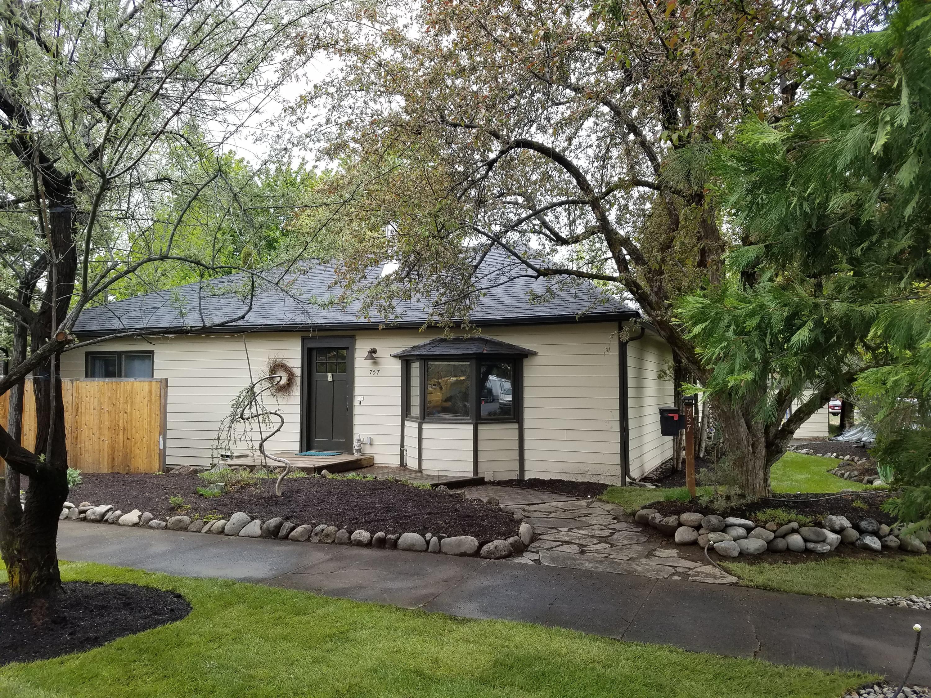 Single level home with character and soul not found in newer homes and just 1 block to sought-after Highland Elementary on Bend's westside. Beautifully treed, flat .16 acre, street-to-alley, corner setting. RM zoning allows for additional units (Buyer to do own due diligence). 4 large bedrooms, 1 with access to yard. Approximately 2114sf single level living space PLUS fantastic 16'x16' enclosed sunroom/porch overlooking rear yard with greenhouse AND 552 s.f. clean, well-lit basement. Wood stove in family room for cozy winter days. New roof (2019) and newer gas furnace (2016) and flooring (2018). And New Landscaping and Irrigation! Such a great setting in the heart of Bend! Don't miss the virtual tour!<br>