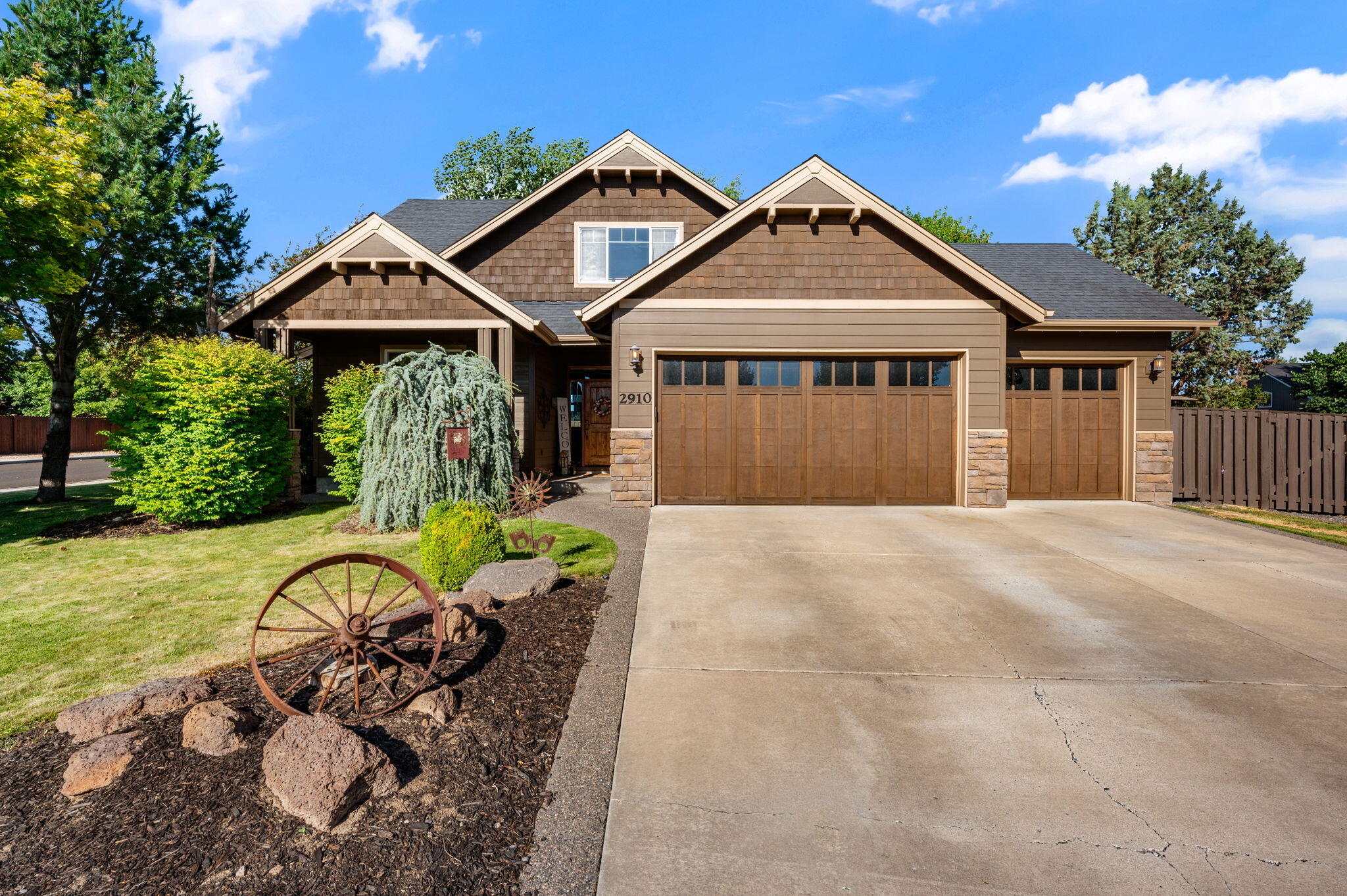 Situated on a desirable corner lot in Redmond's sought-after Canyon Point, this 4-bedroom, 2.5-bath home blends comfort, functionality, and timeless charm. The open-concept layout is filled with natural light and features a spacious kitchen with stainless steel appliances, ample cabinetry, and a breakfast bar that flows seamlessly into the dining and living areas—ideal for entertaining. The primary suite is conveniently located on the main level and offers a private retreat with a walk-in closet and ensuite bath. Upstairs, three additional bedrooms provide plenty of space for guests, work-from-home needs, or hobbies. Enjoy mature landscaping, a fully fenced backyard, and a covered patio perfect for year-round relaxation. With inviting curb appeal, a 3-car garage, ample space for RV Parking, close proximity to the Dry Canyon Trail, parks, and NW Redmond amenities, this home offers the best of Central Oregon living.