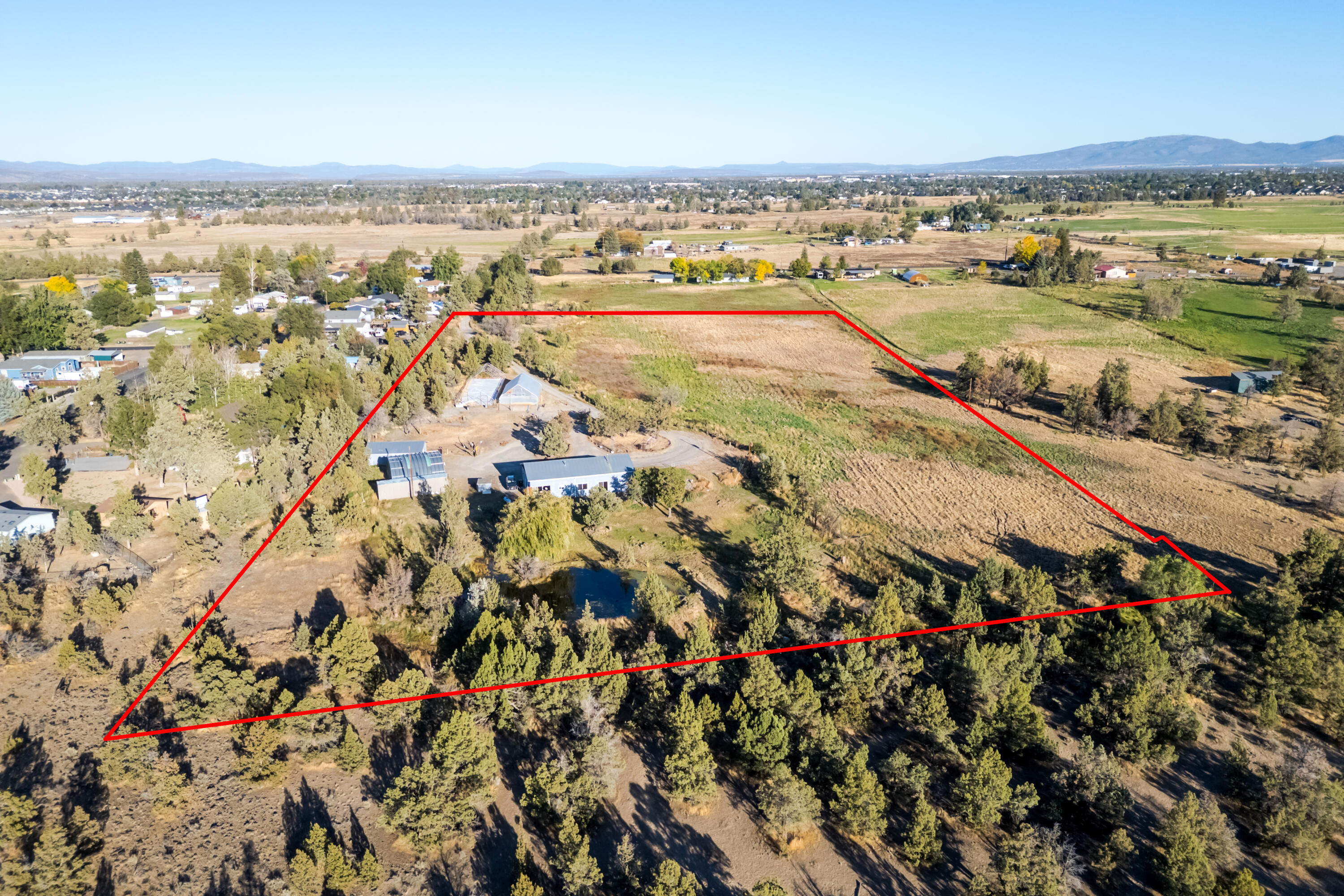 CASCADE Mountain Views on a 10-acre lot with 8 acres of irrigation. The home is 1600 sq ft, with 2 bedrooms and 1 bath, and includes a 1178 sq ft shop and a 2-stall horse barn. This property offers a great opportunity for buyers to improve the existing house or build new. Home sits to the back of the lot off the road for quiet privacy overlooking a pond with Mountain Views beyond. Property has been used for agricultural as well as a horse boarding facillty.