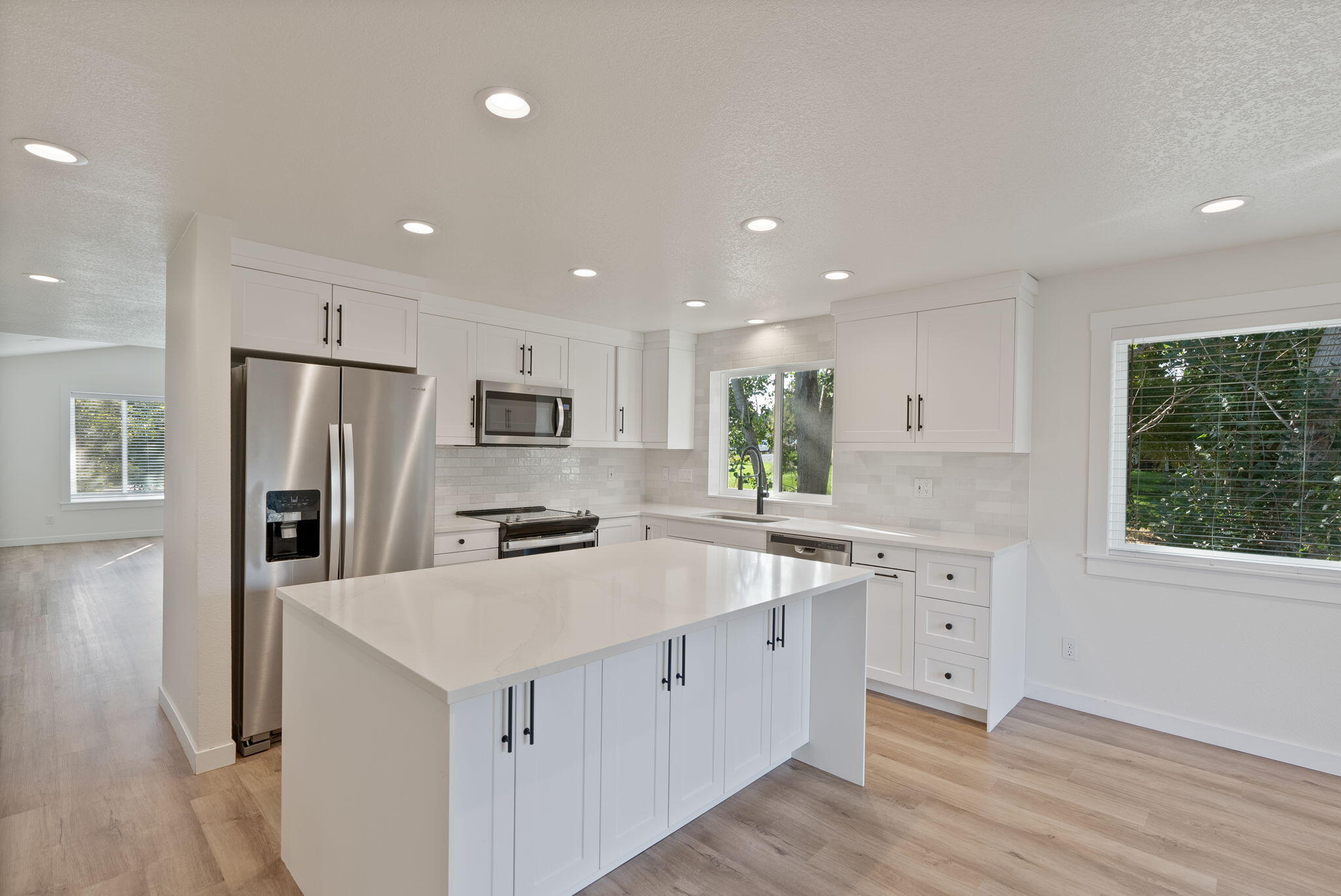 Discover refined multi-generational living in this fully remodeled home on a premier .40-acre corner lot.  Best deal at just $347 per sq foot! Both levels of this home can be entered with zero steps. Thoughtfully designed with two full kitchens and two garages, this residence offers versatility and elegance throughout. The private lower level features its own entrance, garage/storage area, 3 bedrooms, 2 baths, kitchen, laundry rm, and patio area—perfect for extended family or guests. Septic was cleaned/pumped/inspected in Oct 2024 (concrete tank!), there is a newer roof, and new upper deck ensuring comfort and peace of mind. With space for an RV or boat and expansive outdoor parking, this home blends function with sophistication. Ideally located near Costco, shopping, and all of Bend's finest amenities, it is truly a rare find. Book your showing today! Mortgage savings may be available for buyers of this listing.