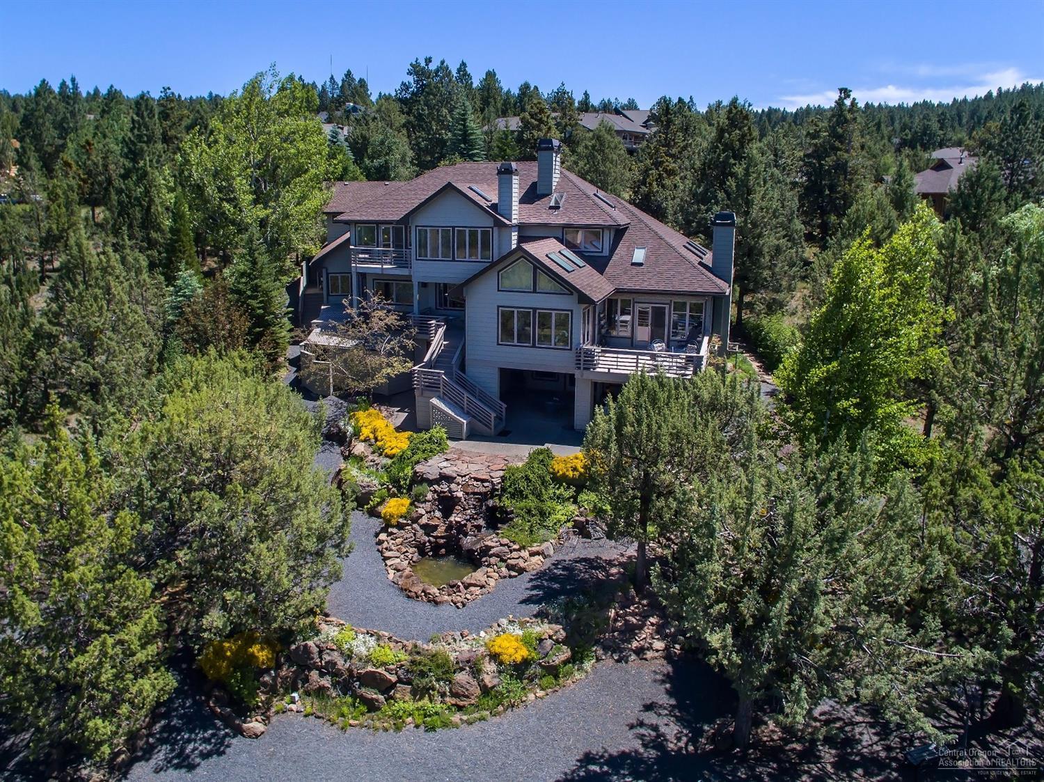 Enjoy the stunning Panoramic Cascade Mountain View from nearly every room in this custom home. This very light & bright multigenerational flowing plan w/bamboo hardwood floors & vaulted ceilings. A charming kitchen, lg. center island, slab granite & sunroom to enjoy the glorious views. The master suite features a floor-to-ceiling fireplace & private deck. Lower level steps you down to the 20x24 indoor pool w/access to the lower patio & optional fitness room. Mature xeriscape garden, pathways & water-feature