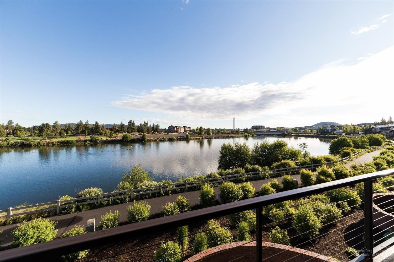 Stunning home on the banks of the Deschutes, with Cascade Mountain views, now available. Desirable Deschutes Landing is steps from the Old Mill District with a plethora of dining, shopping and entertainment. Enjoy the sunsets and concerts from any of your 3 decks. Master suite on the main level has a generous walk-in dual head shower, built-ins and gorgeous views. Downstairs is a huge media room with wet bar and 2 guest rooms. Wine cellar tucked downstairs. Beautifully appointed, rare opportunity in Bend.