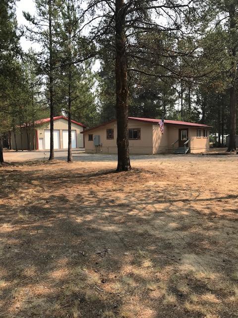 Location and Privacy!  Don't let this one slip away. Great investment opportunity, vacation get away or make it your permanent home. Property is nicely groomed, fully fenced and gated.  Close enough to town for shopping and services and minutes from Class A fishing, skiing and all the wonderful recreation Central Oregon is famous for.  Many upgrades to a classic 1982 Fuqua manufactured home, including new 200 Amp electrical service, new well and pump, new fiberglass septic tank, fresh paint and new laminate floors. Sale includes all appliances.  The huge 1536 sq. ft. shop is amazing . . . fully insulated with new 200 Amp service, 2  12' roll up doors and separate man door. Great for storing all the toys, small business equipment or hobbies.  Located in popular Evergreen Park on paved roadway. Make an appointment and make this home yours TODAY!