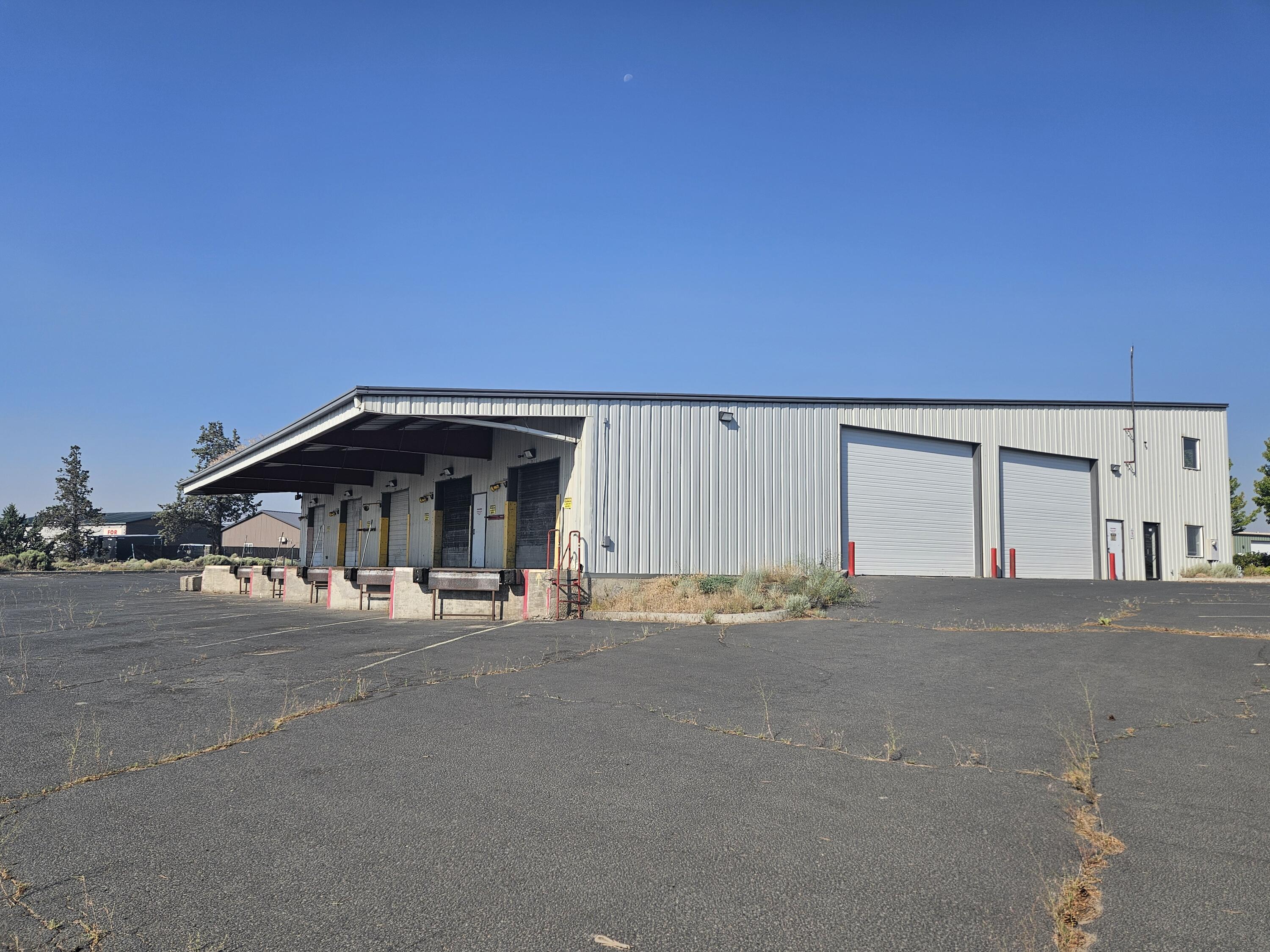 This 9,850 SF Industrial Building in Redmond is a great Owner/User or Investment property. The adjoining lot (.43 Ac.) at 2156 SW 2nd (Map and TL 151321AD01700) is included in this sale creating a total area of 1.42 total acres. The building was originally built for Roadrunner Courier/Express and later occupied by Diamond line trucking, features 5 dock-high loading doors as well as 2, 20' high roll-up drive through doors on both the North and South side of the building for easy delivery and shipping. The large warehouse area is open and is complemented by a reception area, 3 private offices, a break room and restroom. The roll-up doors have been either serviced or replaced. There is also a large second floor area over the offices with nice views for meetings or additional storage.
