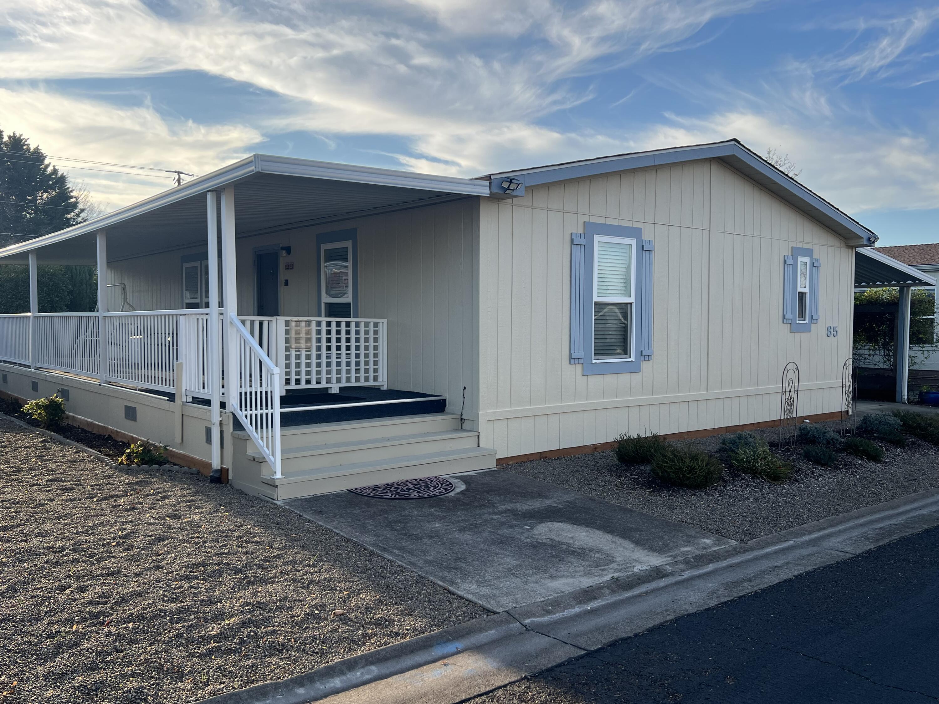 TThis move-in ready, well-maintained manufactured home offers a bright, open floor plan with vaulted ceilings and a spacious living area. The kitchen features a skylight and comes with all appliances, including a washer and dryer. Recent upgrades include a new HVAC unit with a transferable warranty, new flooring, cabinets, and countertops, upgraded windows with blinds, and fresh skirting. Outside, enjoy a low-maintenance yard with Talent Irrigation water for landscaping, a large covered deck, fenced and gated areas, plus a covered carport with a storage shed. Situated in the desirable Candlewood Mobile Estates 55+ community.