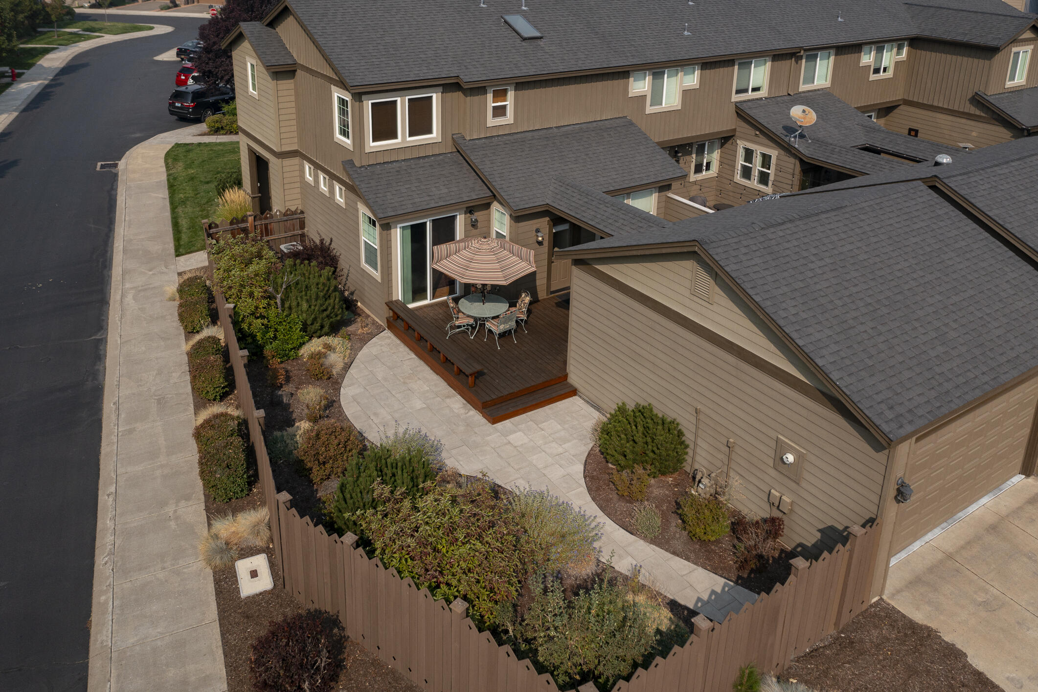 Live and play right where the action is! This Deschutes Model town home is steps from Old Mill, river, parks, shopping, dining & entertainment - everything Bend has to offer. Corner lot provides room for private, fenced courtyard with low-maintenance landscaping and cedar deck. Home borders common area and has 5-mountain, 2nd story view. Newer carpet, maple hardwoods, dishwasher. New spa installed in private courtyard enclosure in 2017. Interior finishes include granite tile kitchen counters, tile bathrooms, slate in laundry room, gas fireplace in great room and a very efficient floor plan.  Minutes to downtown Bend!
