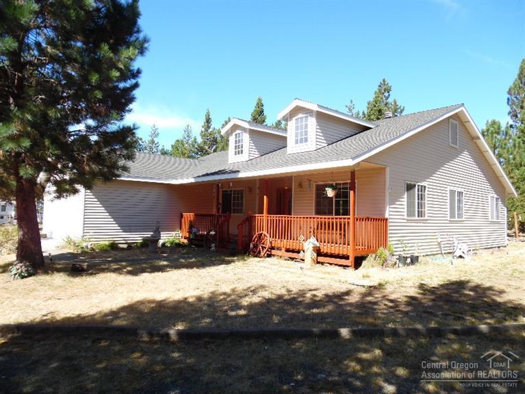 Don't miss this charming single level 1850SF home off paved Sunrise Blvd. Sits on 1.08AC corner lot w/ mature growth for privacy, completely fenced + gated driveway & newly refinished front & rear decks. Includes attached 2 car garage, metal framed carport plus HUGE 1440SF concrete floor shop w/ pull through 16' doors! Light & bright open floor plan w/ vaulted ceilings, laminate wood floors & gorgeous real brick fireplace for cozy winter nights. Spacious master suite w/ jetted tub and access to rear deck.