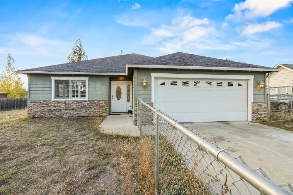 Charming 1644 sqft. single-level home on nearly half an acre! This well-maintained 2007-built, 3-bedroom, 2-bath home features an inviting open floor plan with newer carpet and custom shutters throughout. The spacious kitchen includes granite tile counters, a convenient island, and plenty of storage. Enjoy a comfortable primary suite with a full bath and generous walk-in closet.  The 0.44-acre fully fenced lot offers plenty of room to relax, garden, or play, plus a large shed for storage or hobbies and RV access and parking.  Additional highlights include a 2-car garage, move-in ready condition, and a peaceful setting close to town. A wonderful blend of comfort, style, and function. Schedule your showing today!