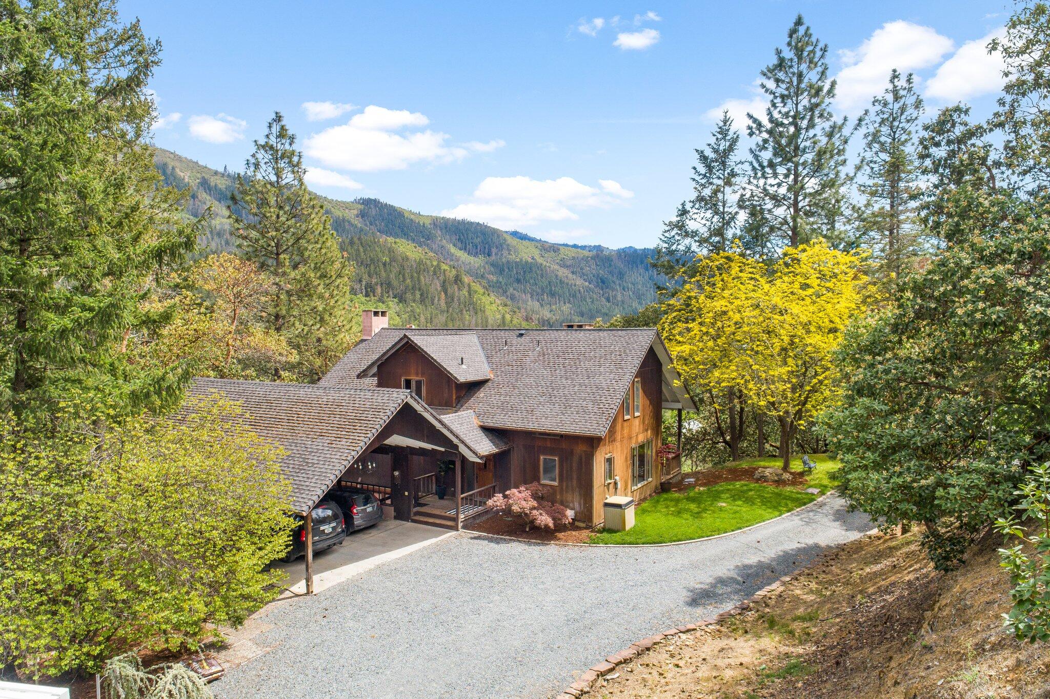 Welcome to this unique, Applegate Valley home & property w/ breathtaking views of surrounding valley, mountains & river! Escape to privacy, yet close enough to all amenities & award winning wineries! Imagine waking up to views of snow capped mountains & ending your day w/ beautiful sunsets & stargazing. Two level home w/ finished daylight basement that includes large rec room, seating area, bed & full bath. Main level features living, dining, office space, full bath, kitchen/pantry, utility room & separate eating area off kitchen. Upper level boasts expansive primary en suite w/ dual vanity, 2 walk in closets. Large, picturesque windows w/wood blinds provide an abundance of natural light throughout! Plenty of storage in the home! Room for RV, trailer or any toys you have! Fire/ember suppression installed w/ hoses & sprinklers on roof. Incredible water pressure w/ 4000 gallon storage tank. This property backs up to BLM and is looking for a new owner to make it their own! Tour today!