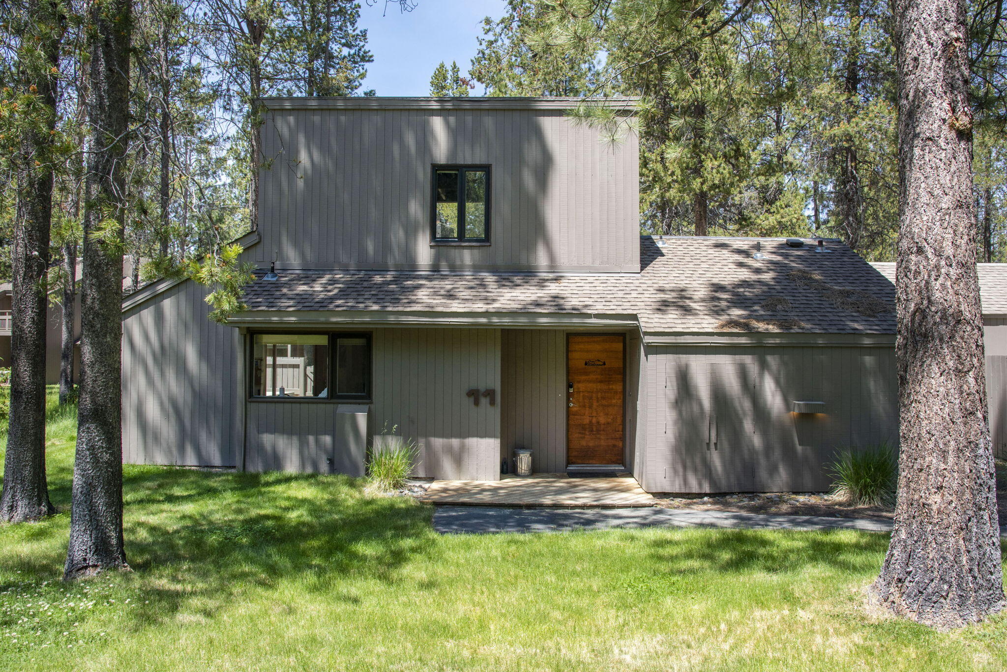 Discover your dream retreat in this charming 2-bedroom, 2-bathroom Meadow House condominium, nestled within the picturesque Sunriver Resort. Spanning 1,230 square feet, this inviting home features stunning vaulted exposed wood beam ceilings and wood accent walls that create a warm, rustic atmosphere. The stone surround wood-burning fireplace in the living area adds a touch of comfort, ideal for chilly evenings. Enjoy the convenience of having the primary bedroom on the main level, while a spacious loft area offers flexible sleeping options for guests. Updated kitchen stainless steel appliances. Step outside to your private deck, featuring a BBQ grill for outdoor dining, and unwind in the hot tub, surrounded by a privacy wall. Custom furniture designed by Russell Forest enhances the appeal of living space. Located on Island Rd, you're just moments from Sunriver Village. Seller is offering $5000 credit towards carpet or closing costs.